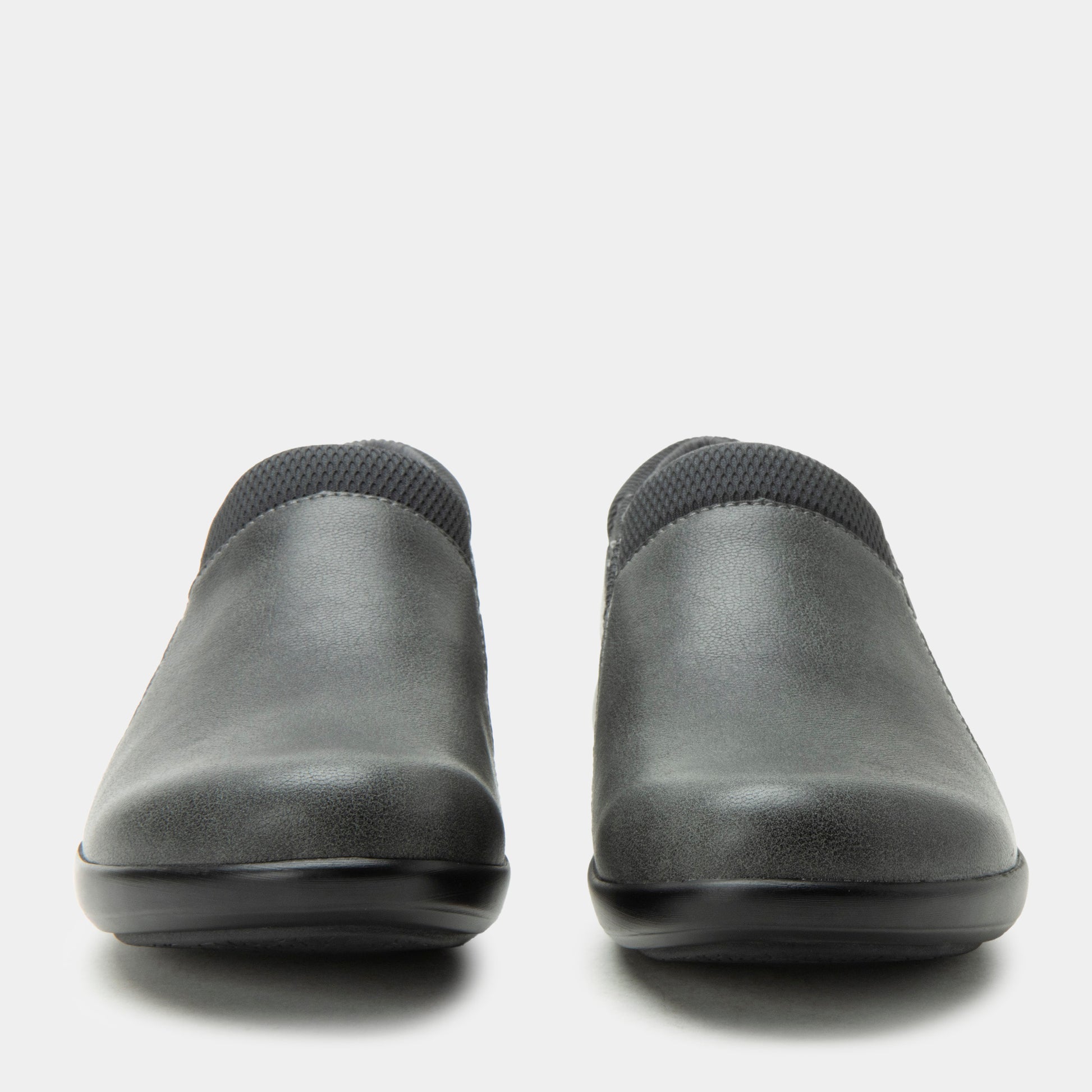 Pair of black slip-on shoes on a white background