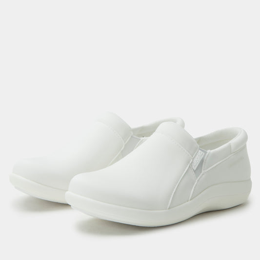 White slip-on shoes on a light gray background