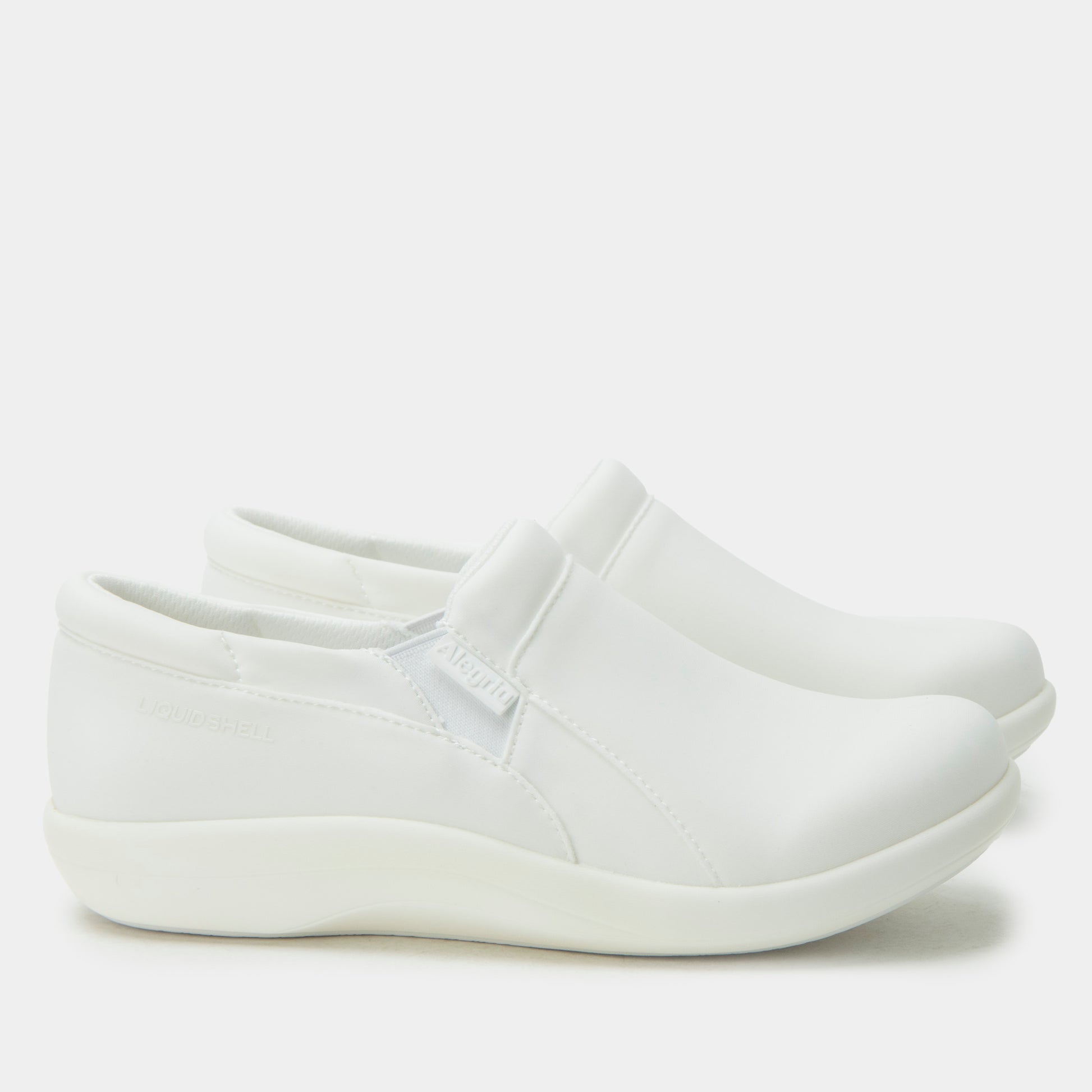 White slip-on shoe on a light gray background