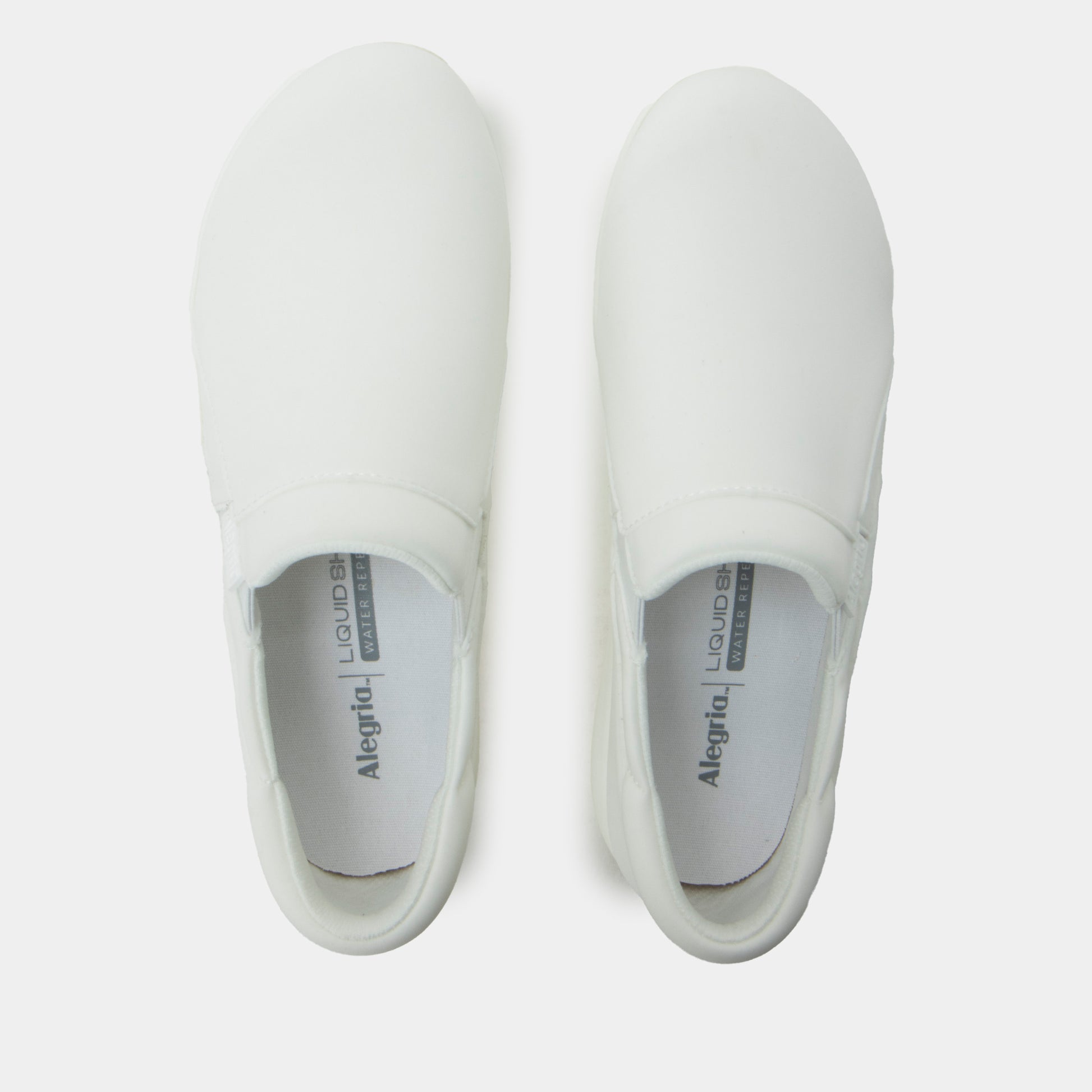 Pair of white slip-on shoes with 'Alegria' branding on a light gray background