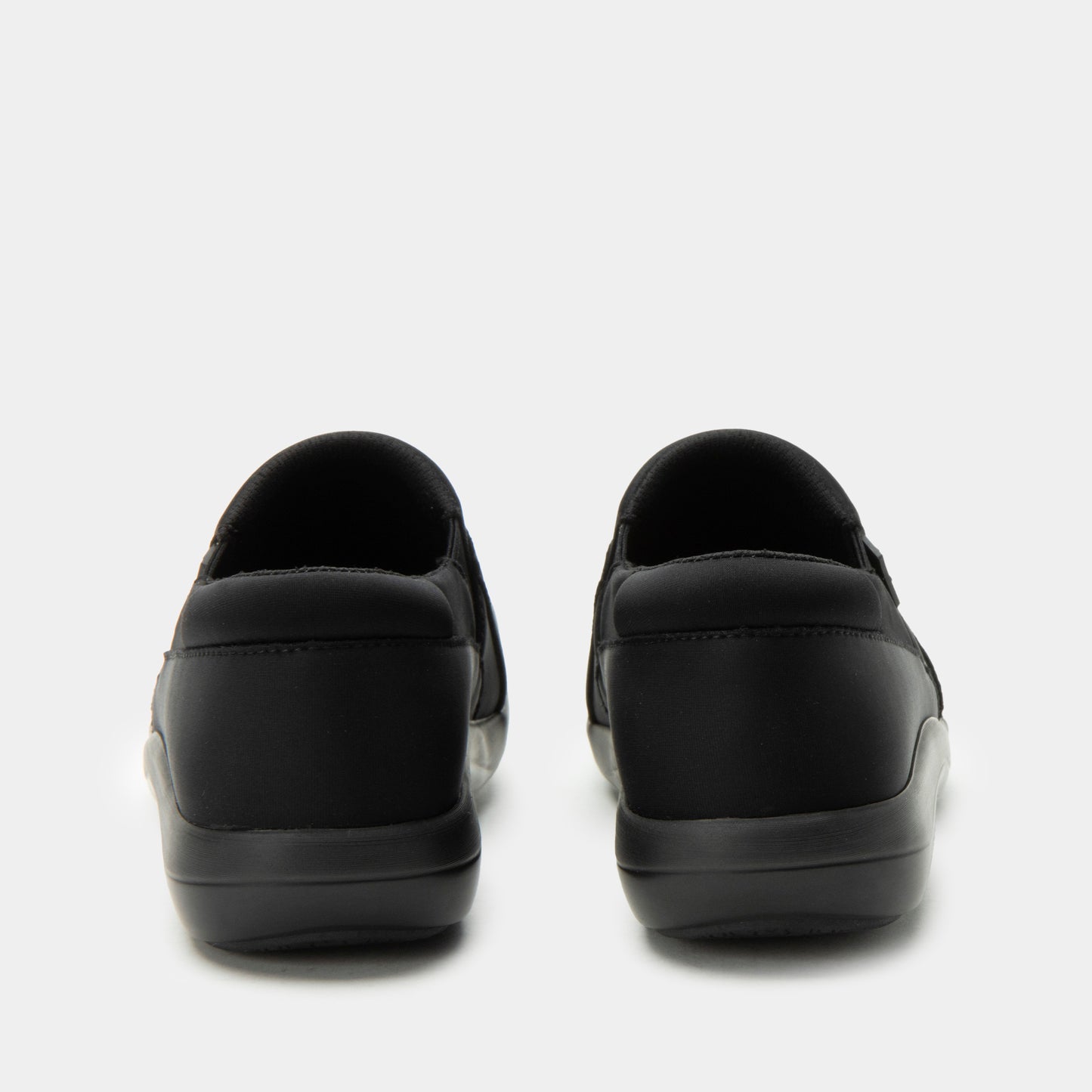 Black slip-on shoes on a white background