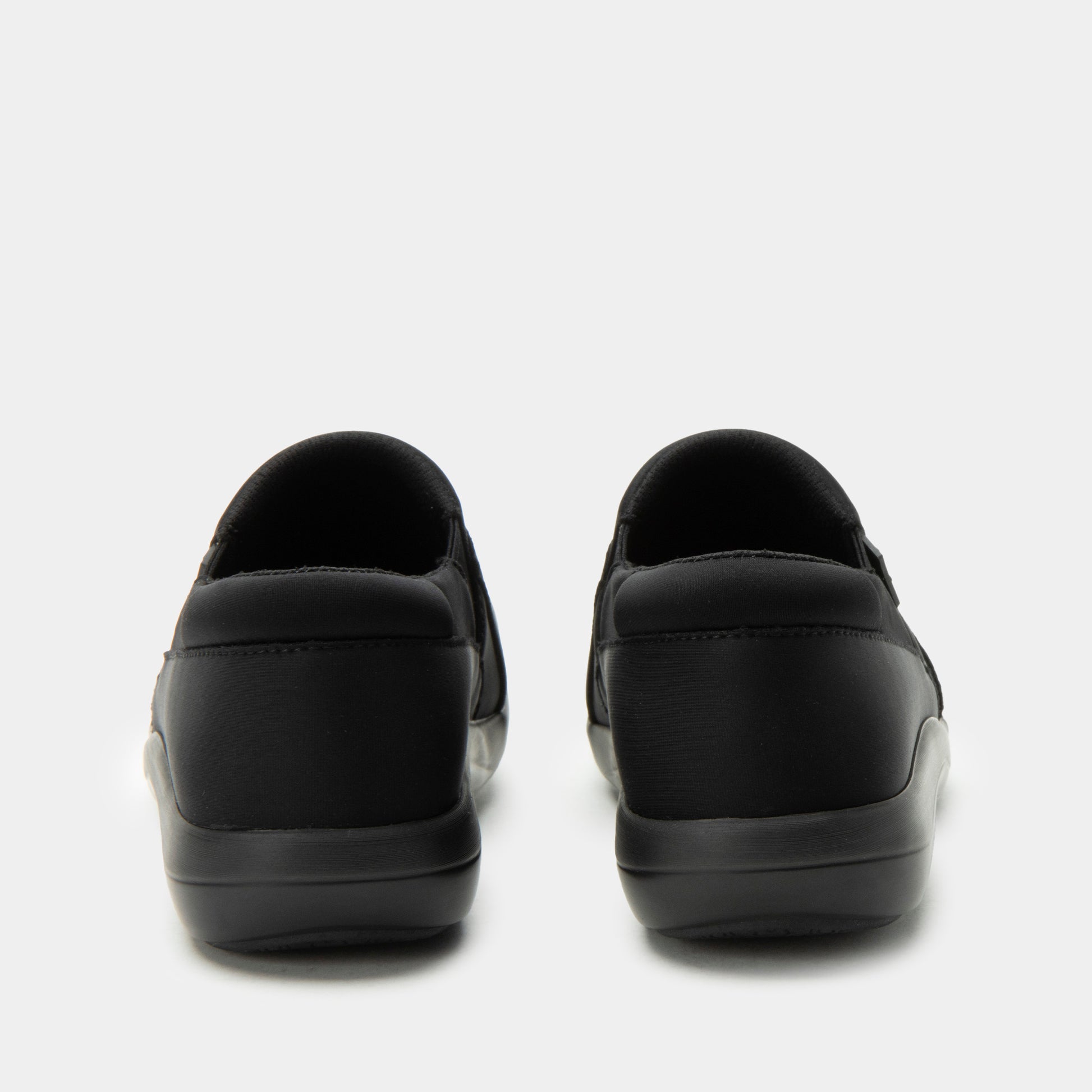 Black slip-on shoes on a white background