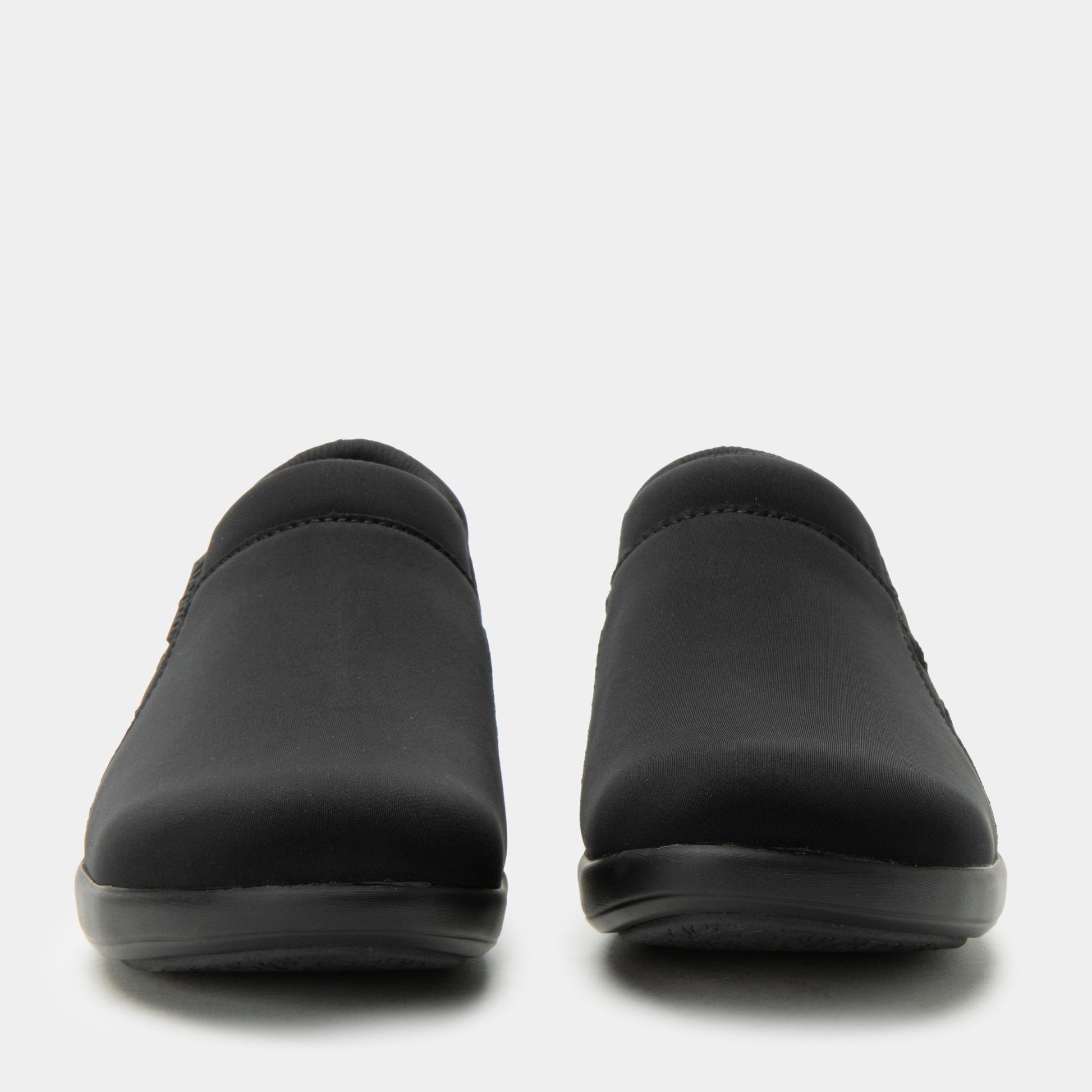 Pair of black slip-on shoes on a light gray background