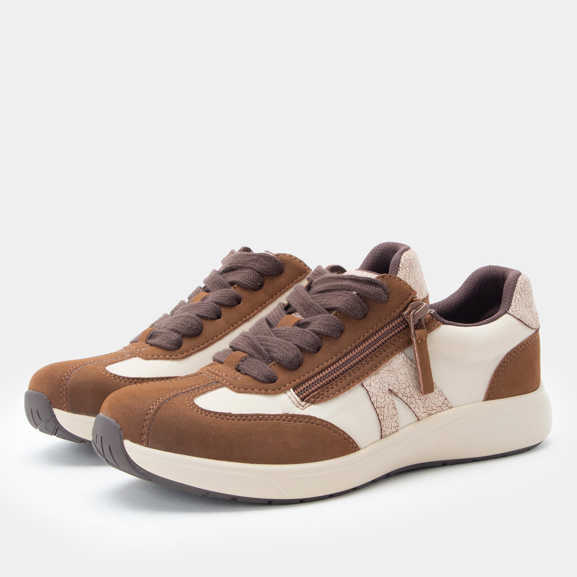 Brown and white sneakers on a light gray background