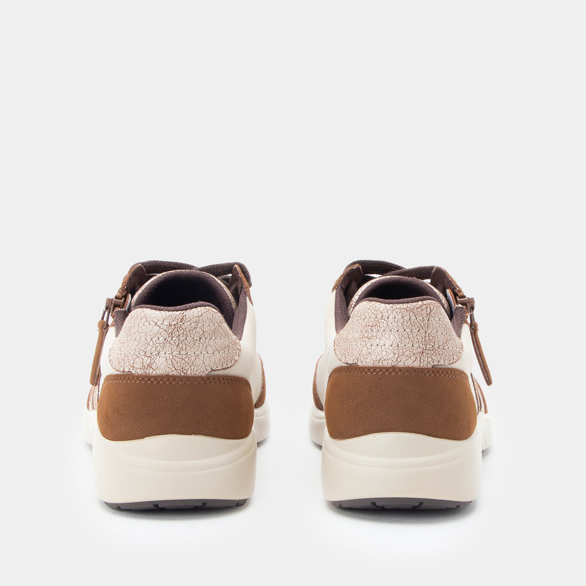 Pair of brown and beige sneakers on a light gray background