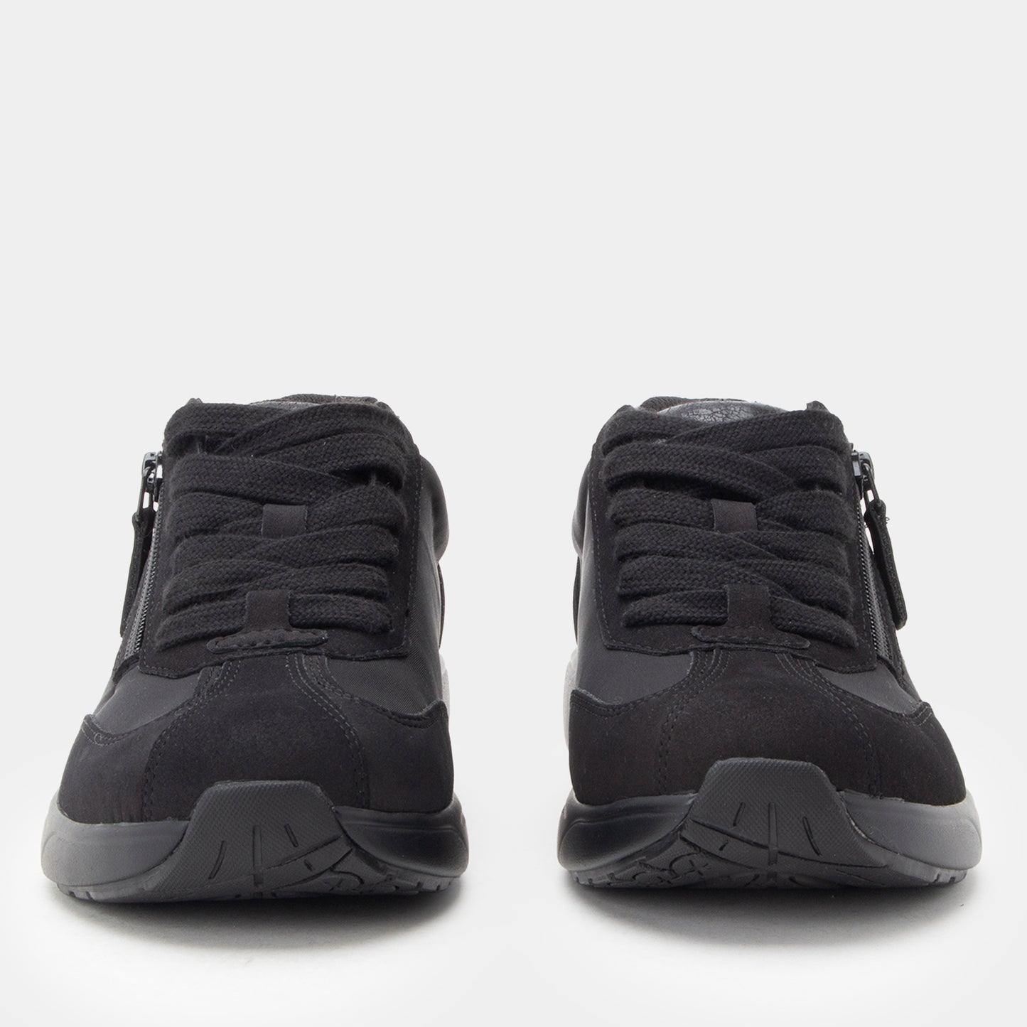 Black athletic shoes with zippers on a white background