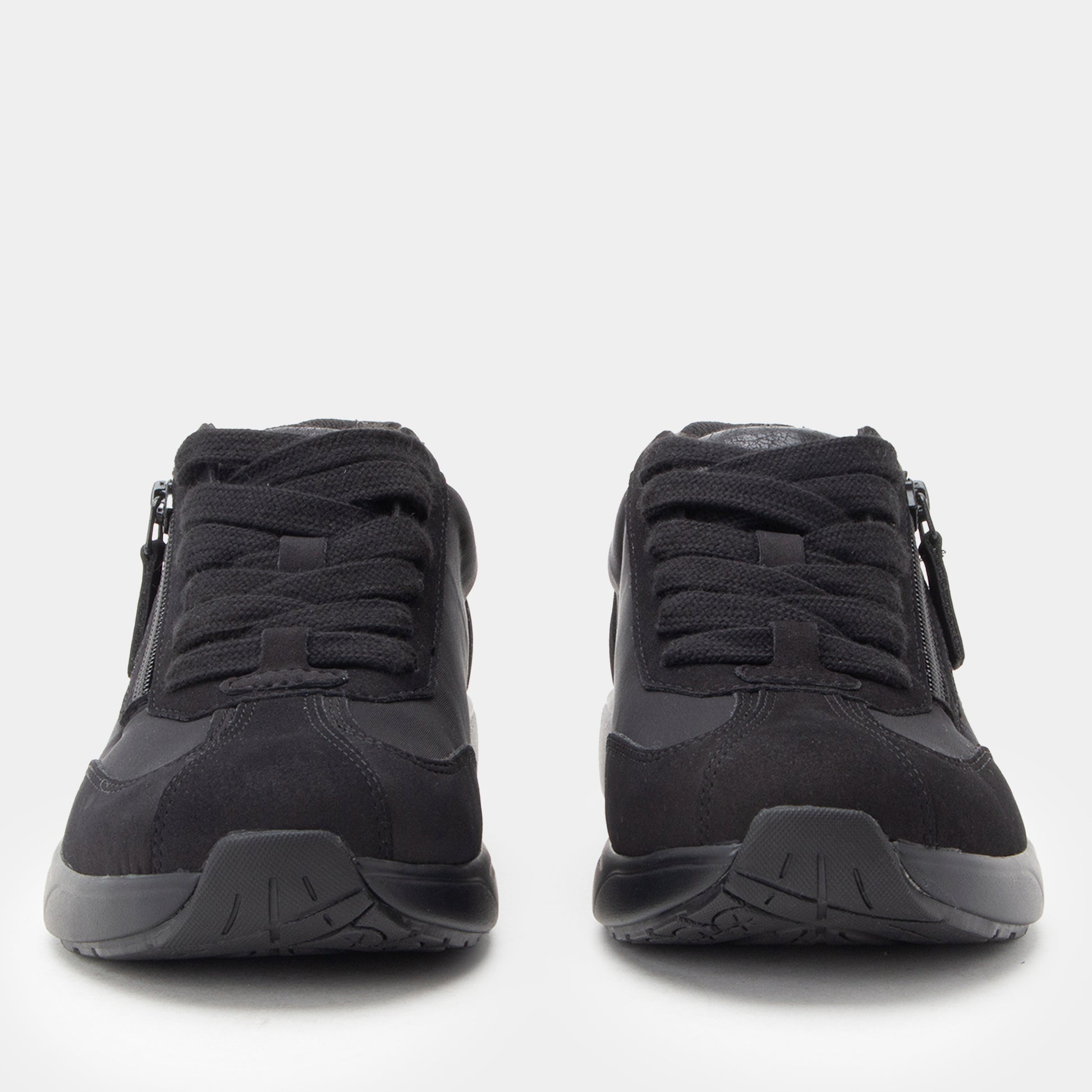 Black athletic shoes with zippers on a white background
