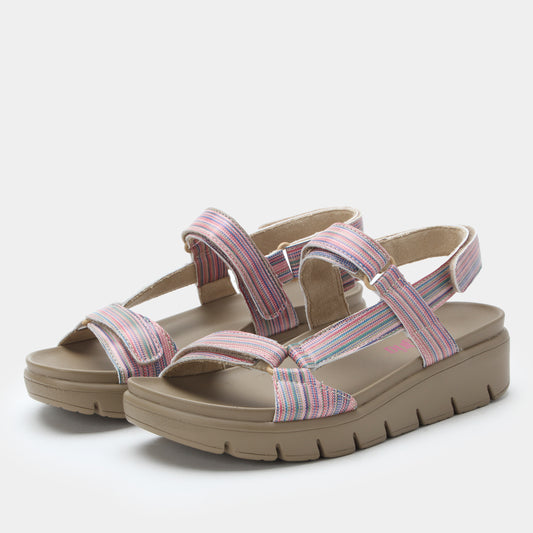 Pair of sandals with pink and purple straps on a light gray background