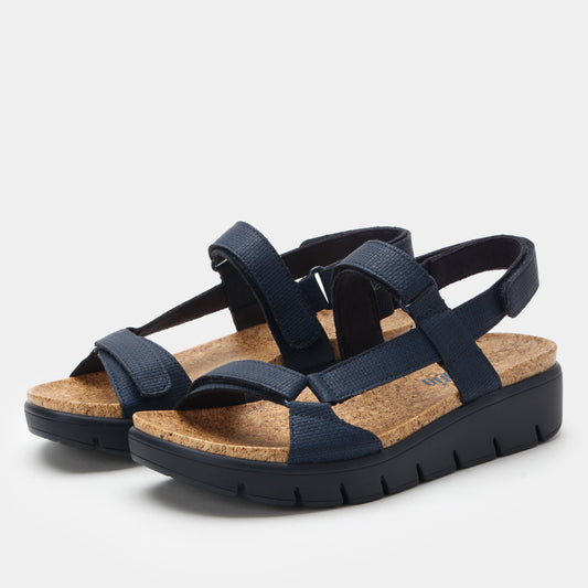 Navy sandals with cork insole on a light gray background