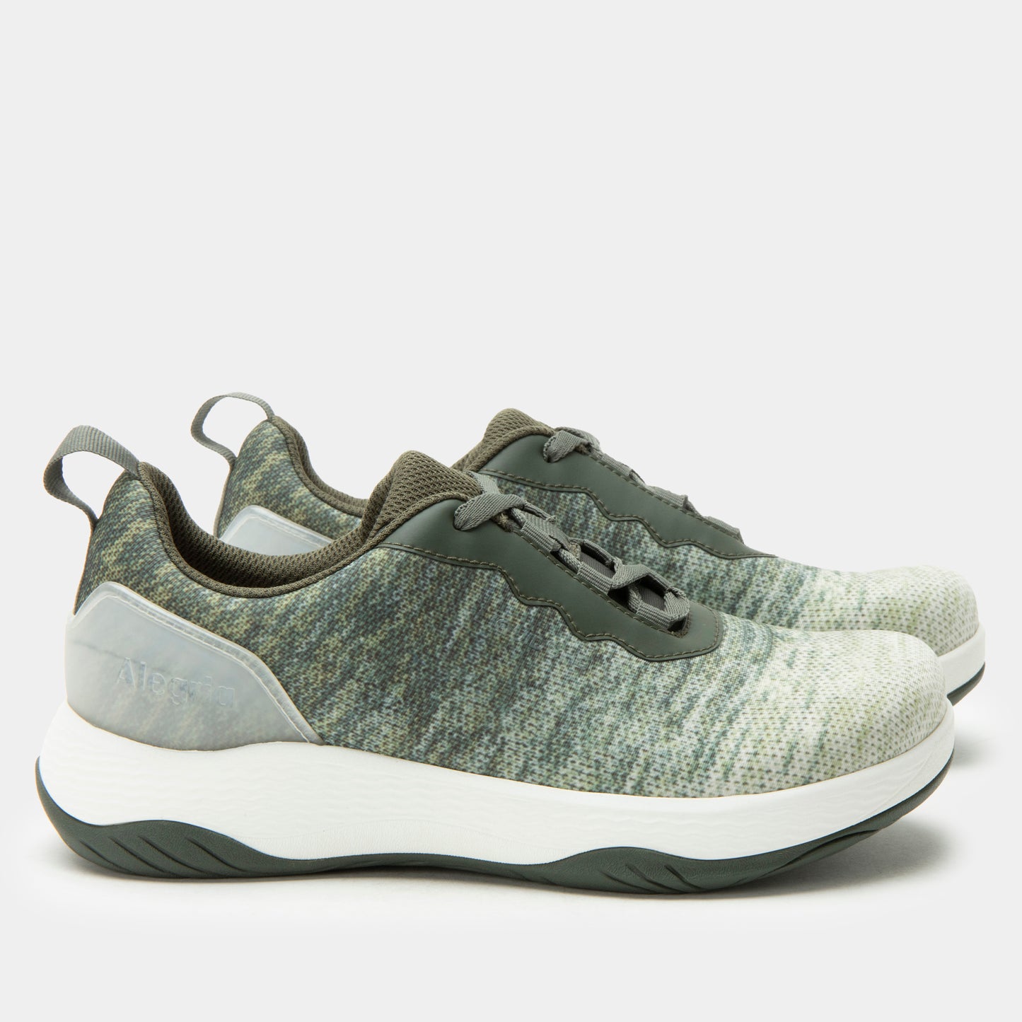 Green and white athletic shoes on a light gray background