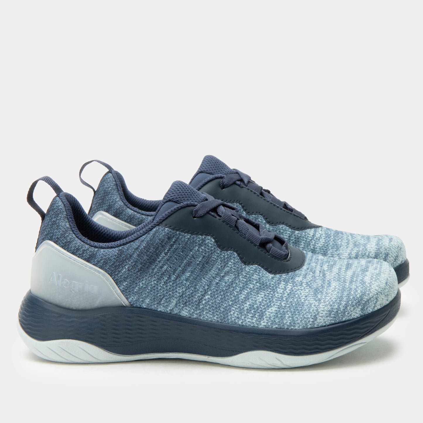 Blue athletic shoes with white sole on a light gray background