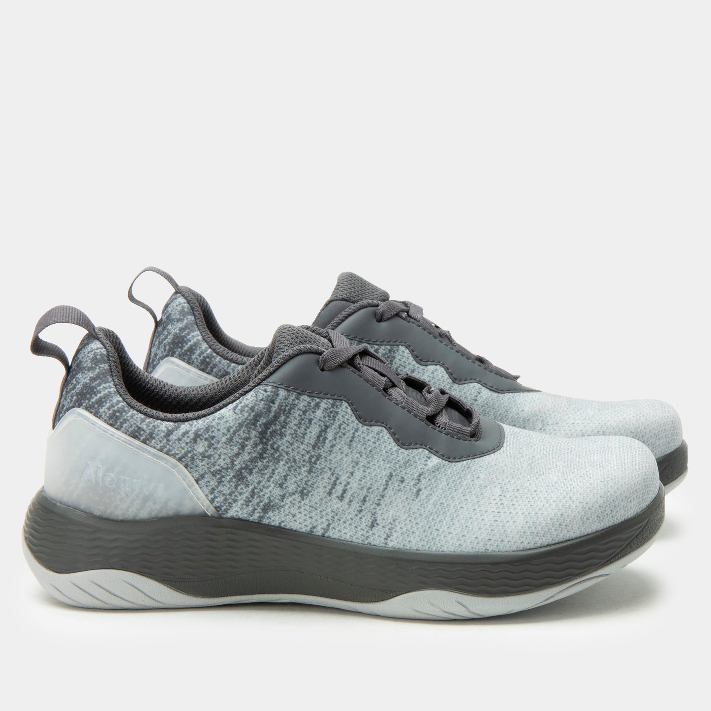 Pair of gray and white sneakers on a light gray background