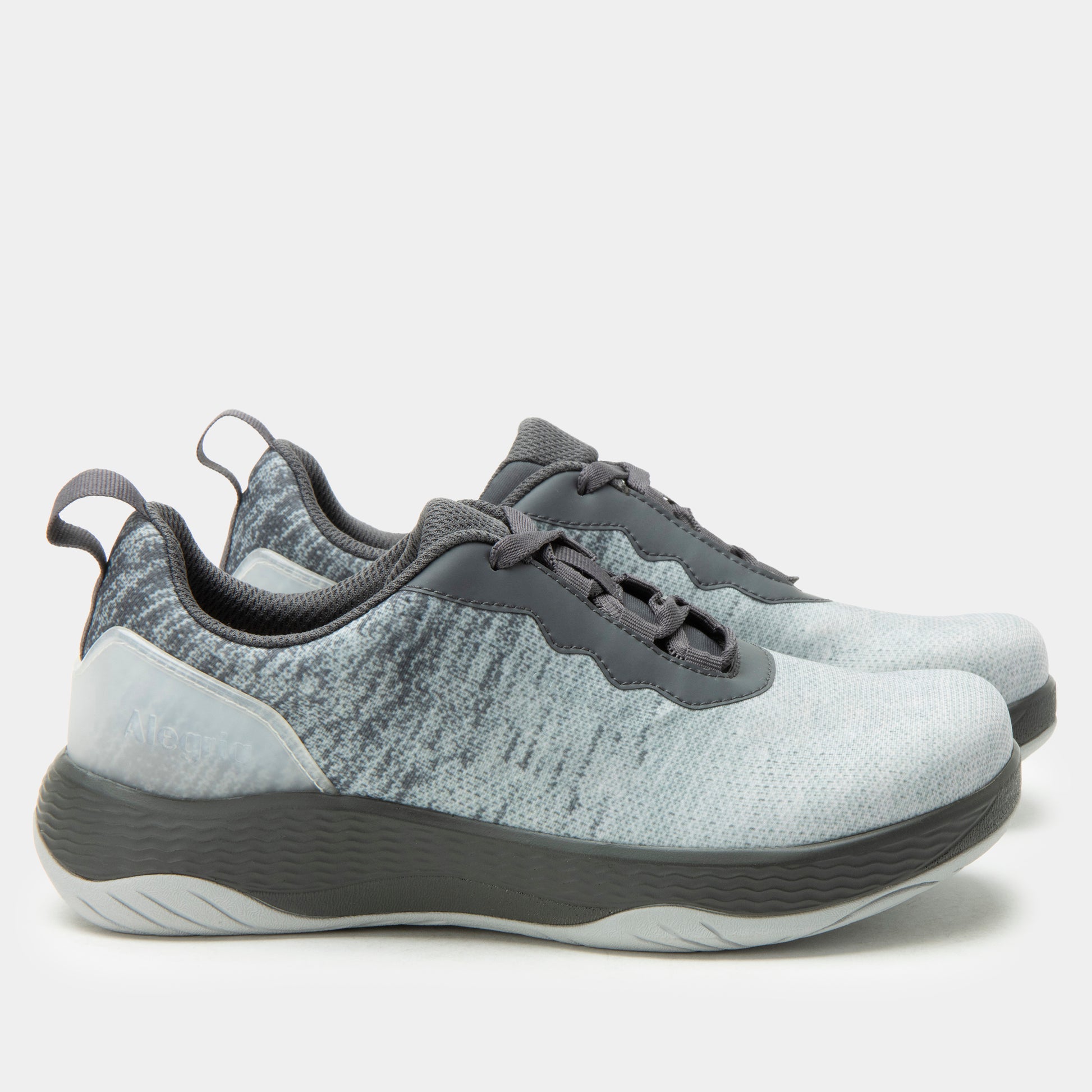 Pair of gray and white sneakers on a light gray background