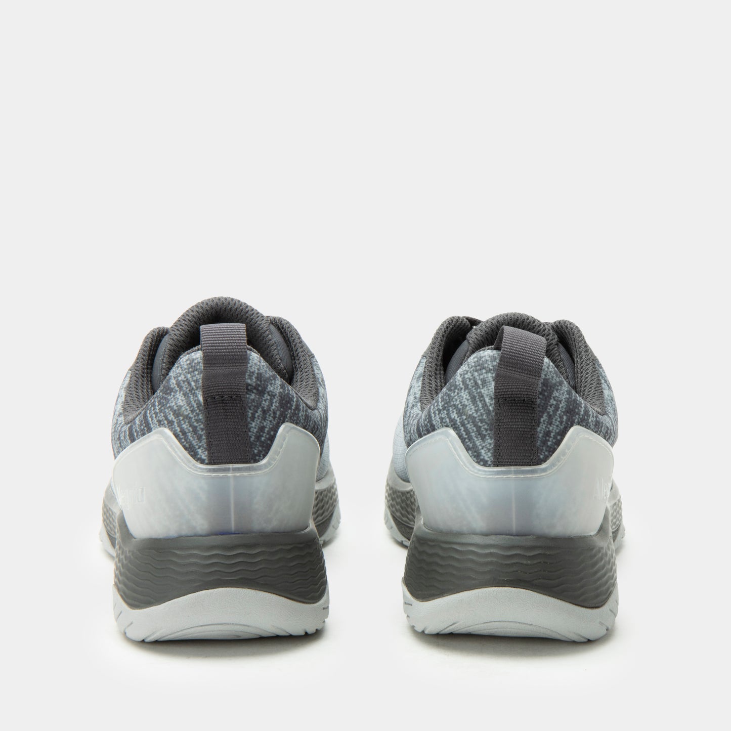 Gray athletic shoes with white soles on a light gray background