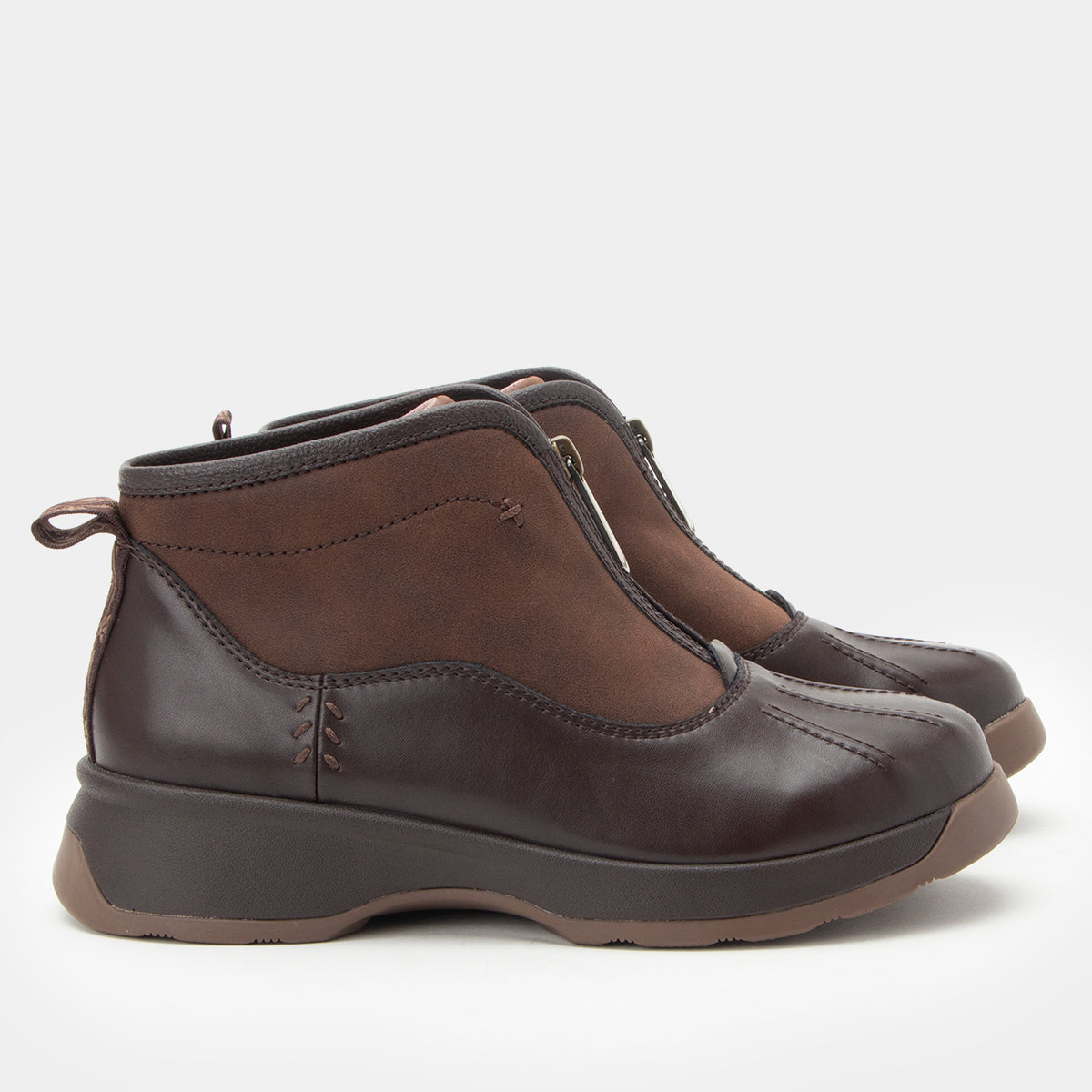 A pair of dark brown ankle boots with a mix of smooth leather and suede-like panels, set against a plain light gray background.
