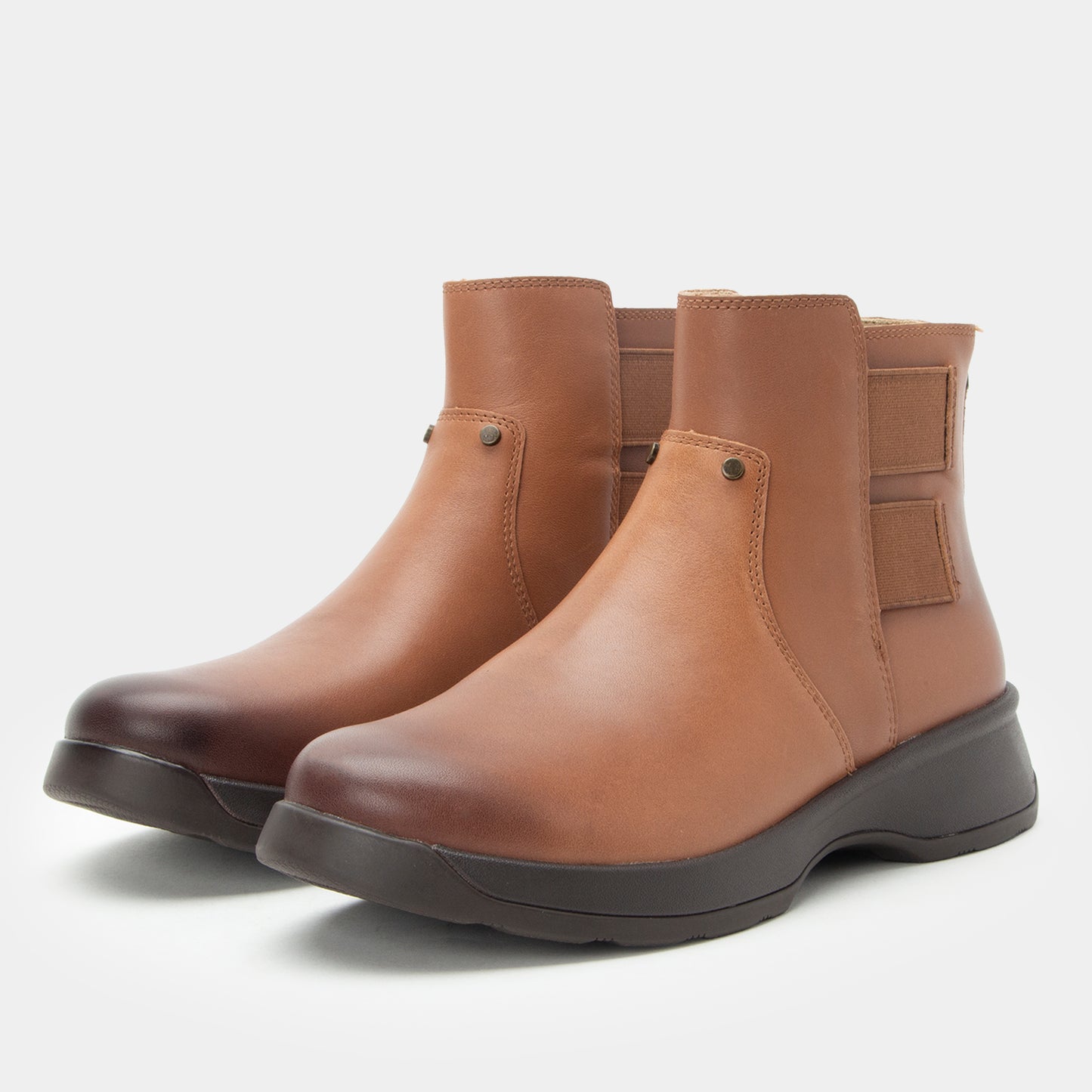 Pair of brown leather boots on a white background