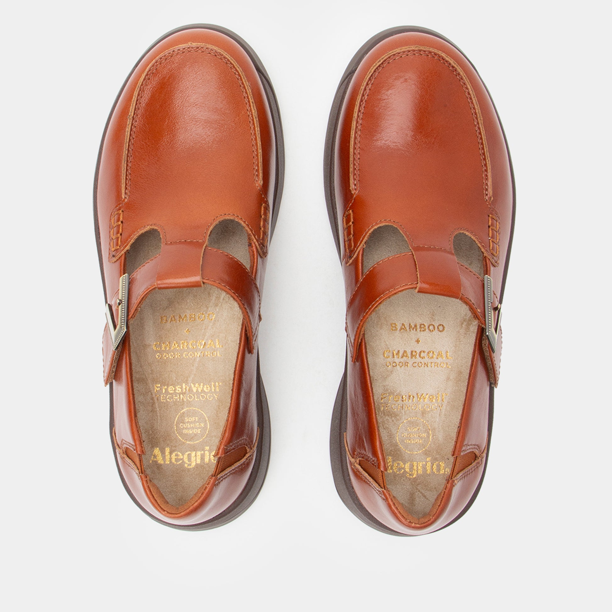 Pair of brown shoes with visible brand name on a white background