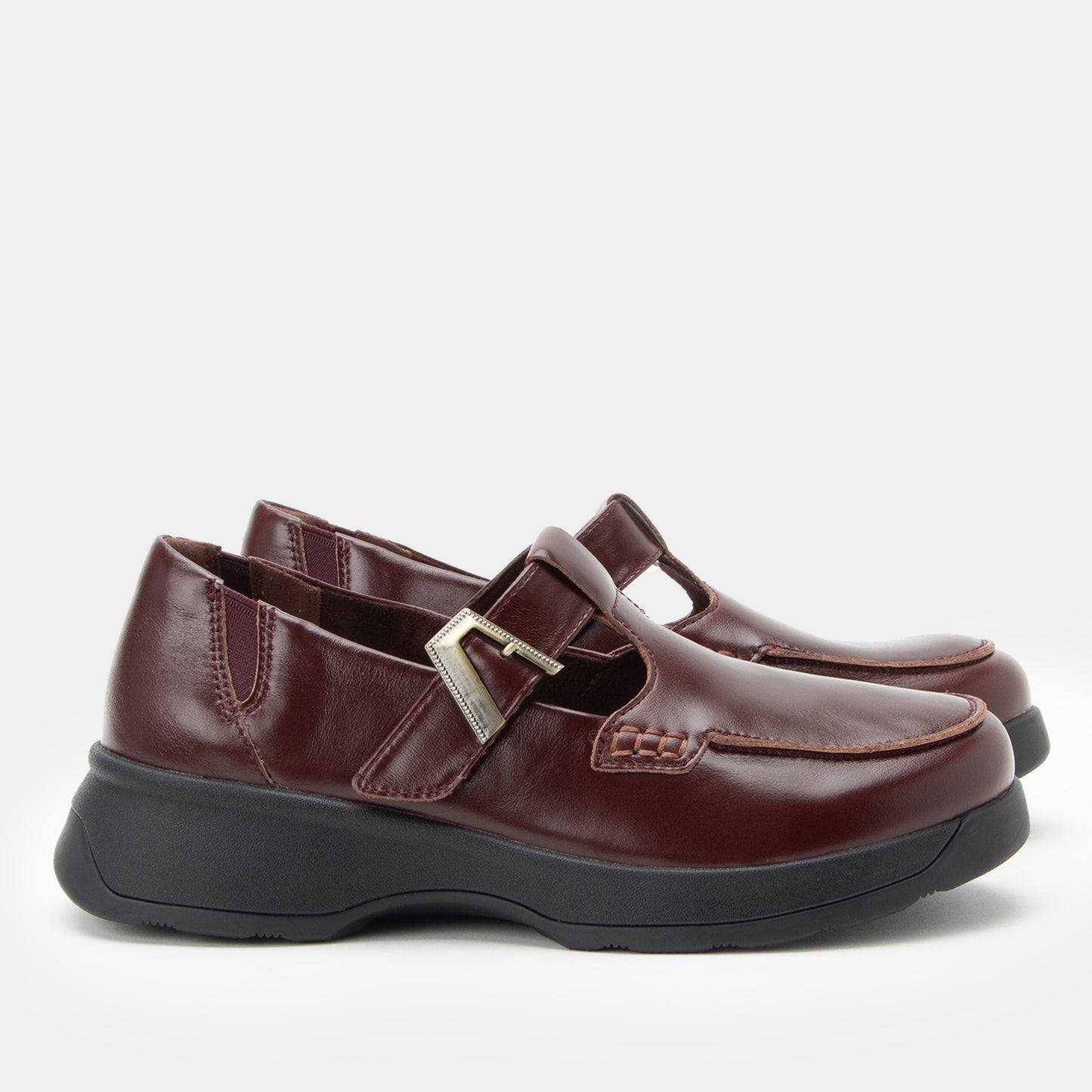 Pair of brown shoes with a buckle on a white background