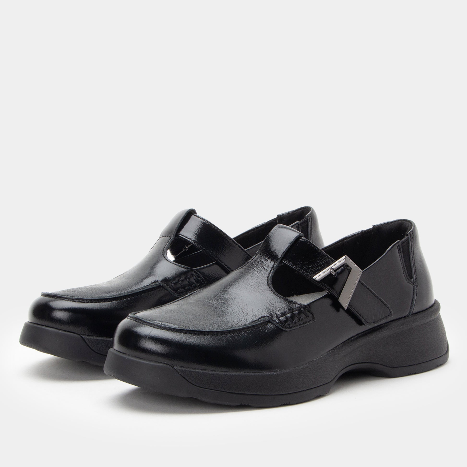 Pair of black shoes with a shiny finish on a white background