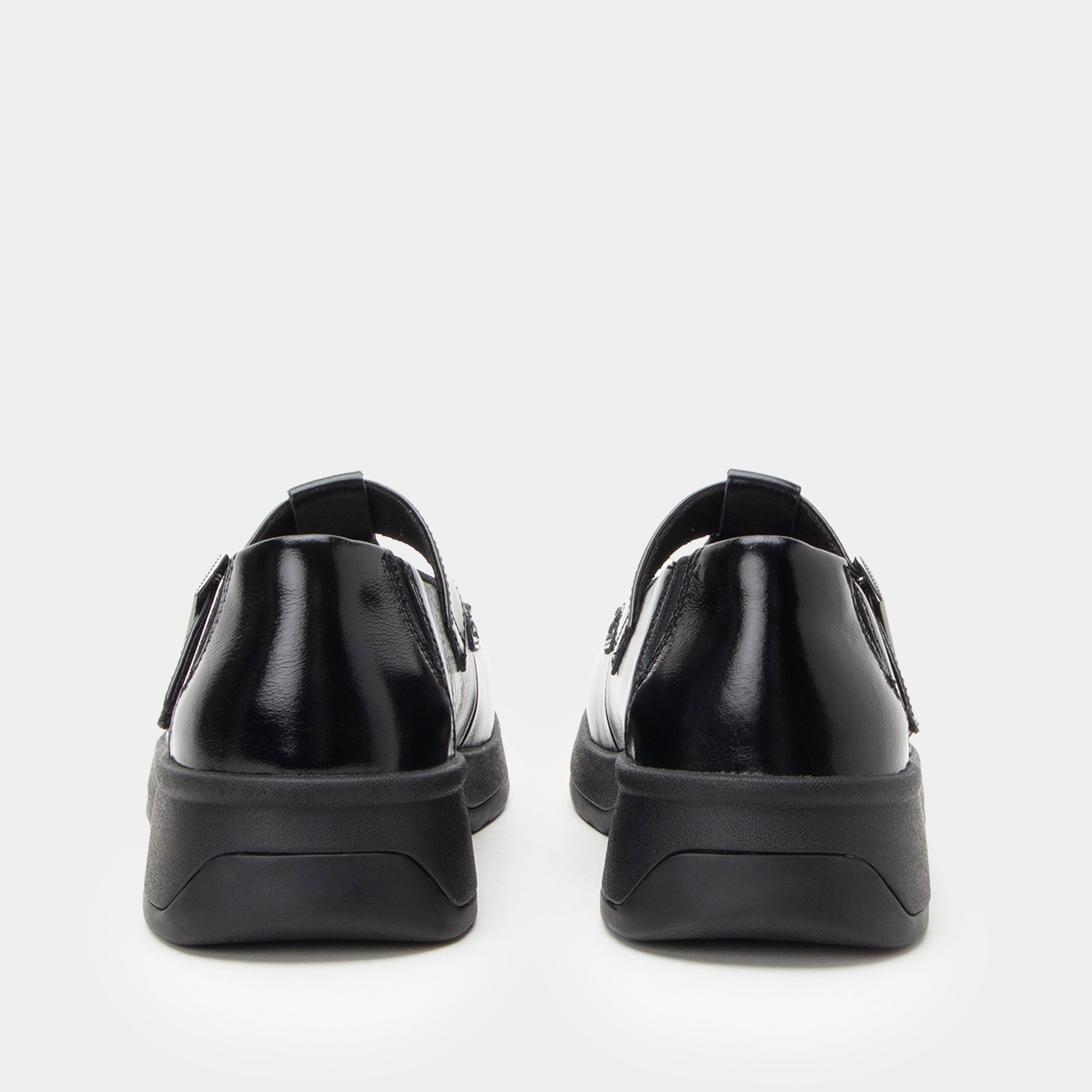 Black slip-on shoes with a thick sole on a white background