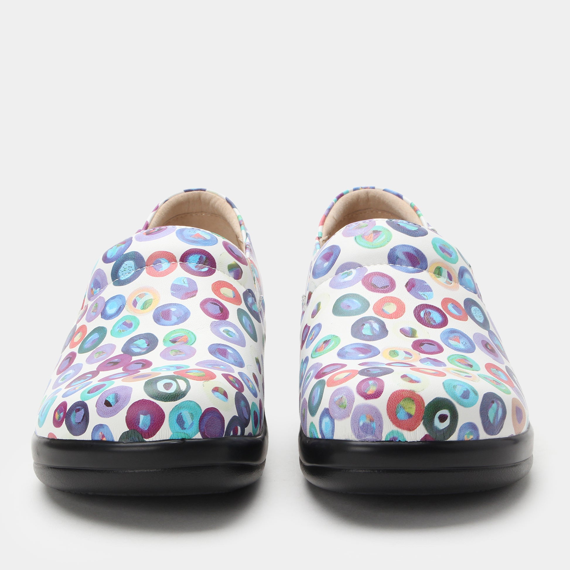 Pair of colorful polka dot shoes on a white background