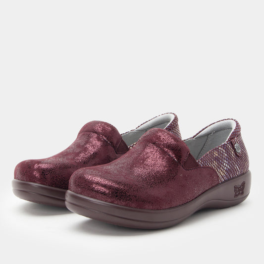 Pair of maroon slip-on shoes on a light gray background