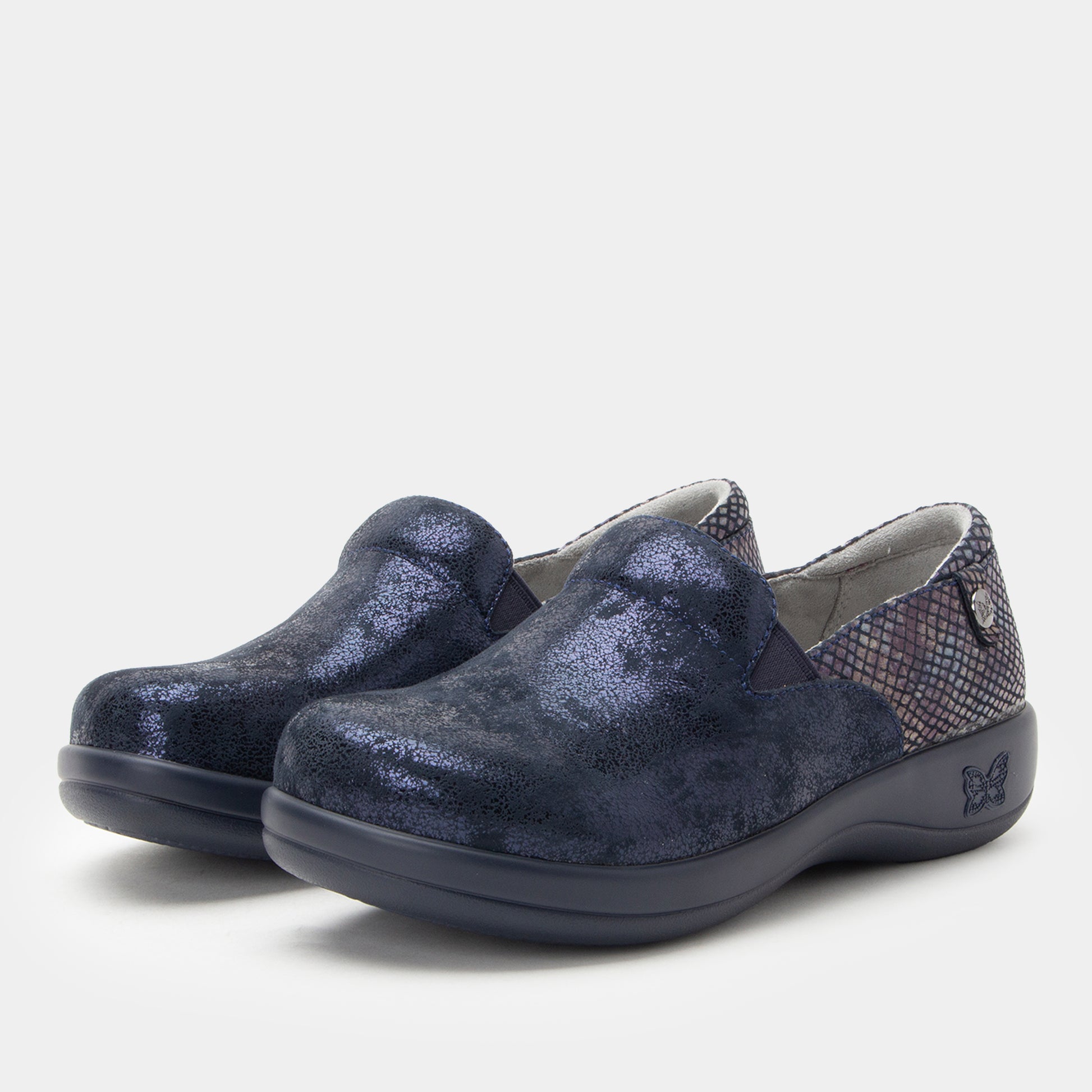 Pair of blue slip-on shoes on a light gray background