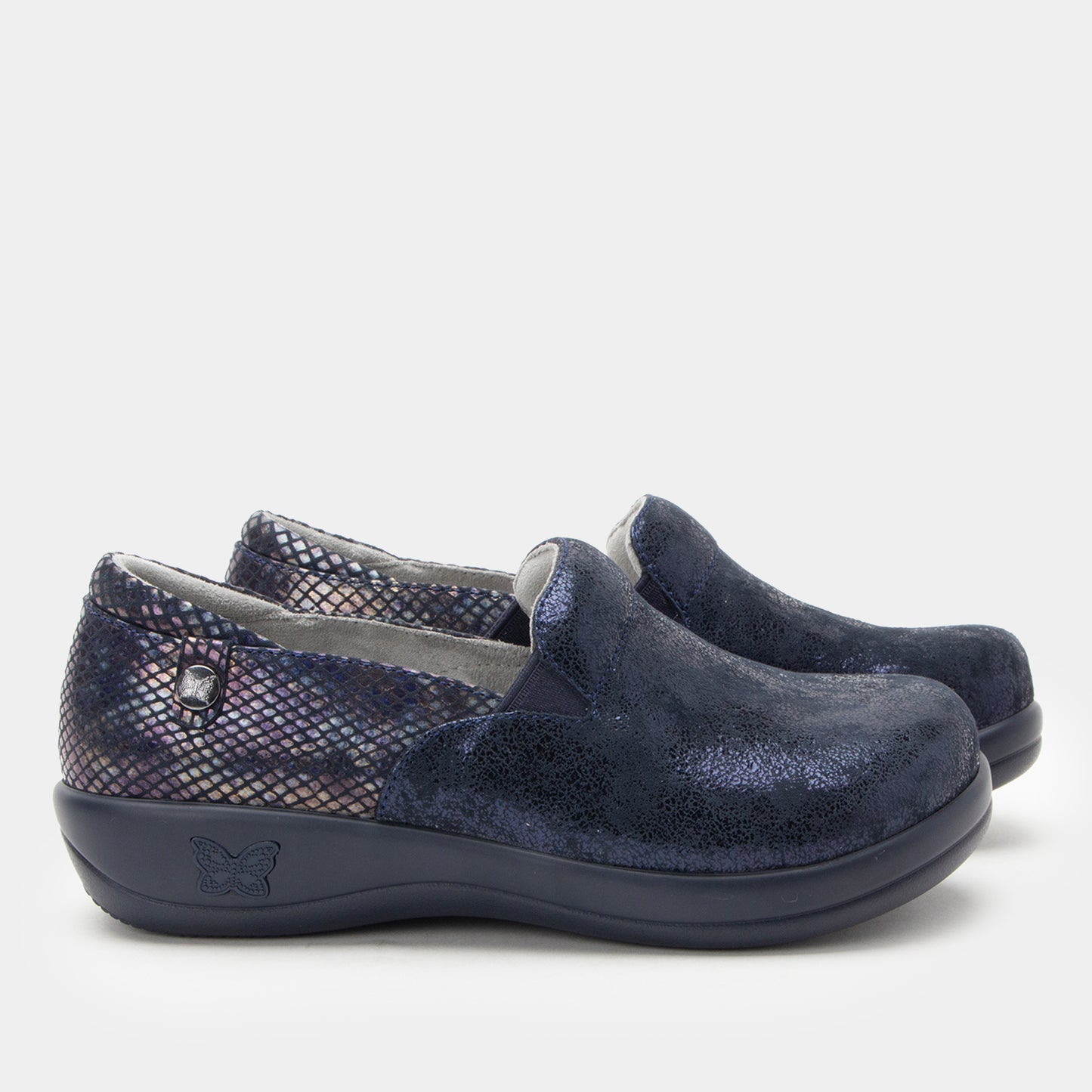 Pair of navy slip-on shoes with textured pattern on a light gray background