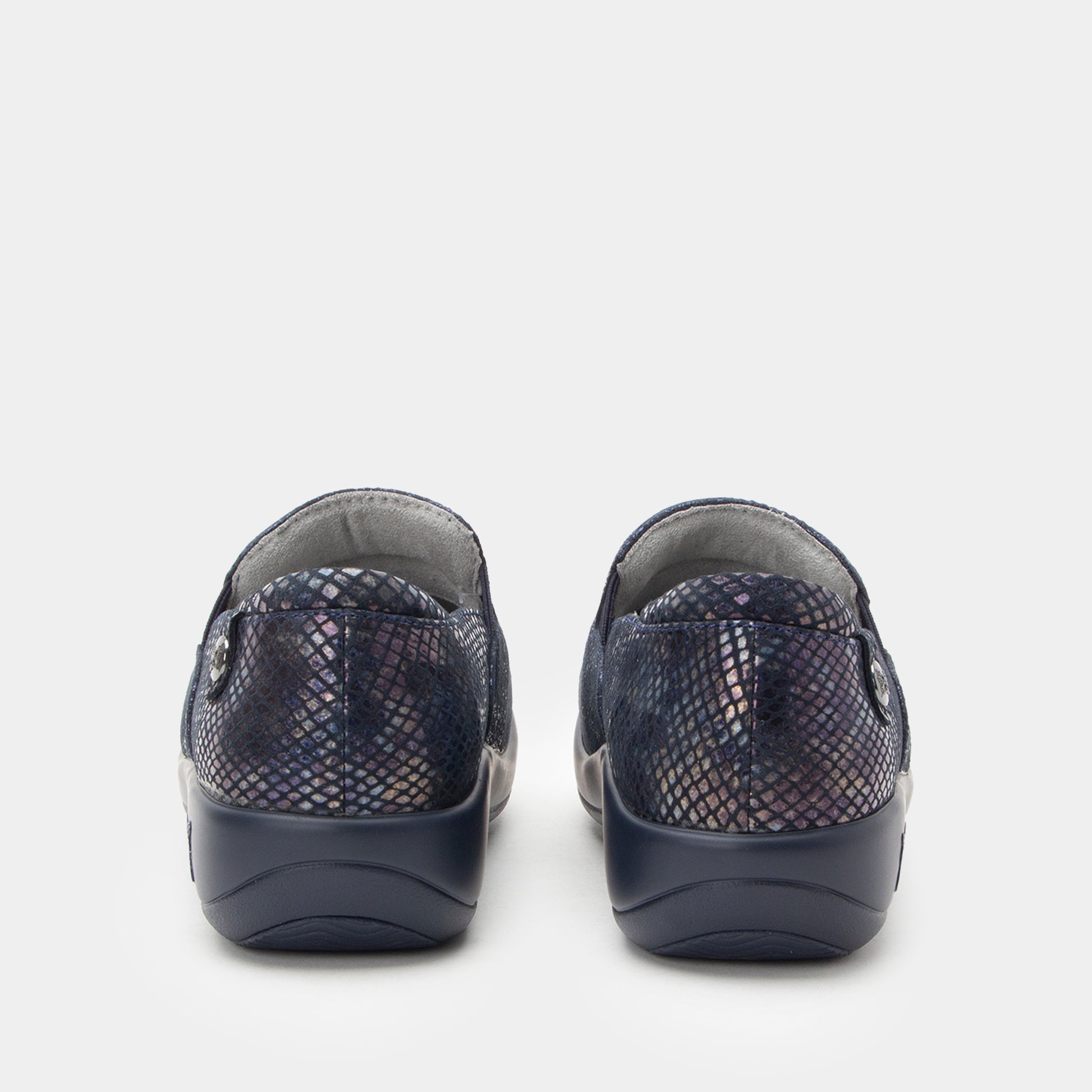 Pair of navy slip-on shoes with patterned design on a white background