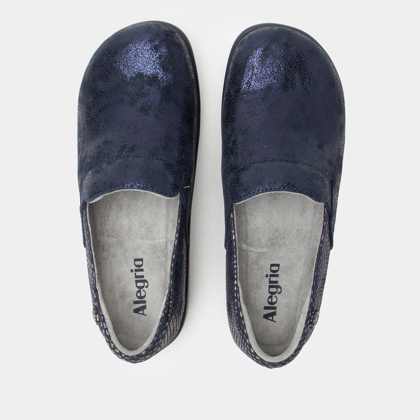 Pair of navy blue slip-on shoes with 'Alegria' branding on a light gray background