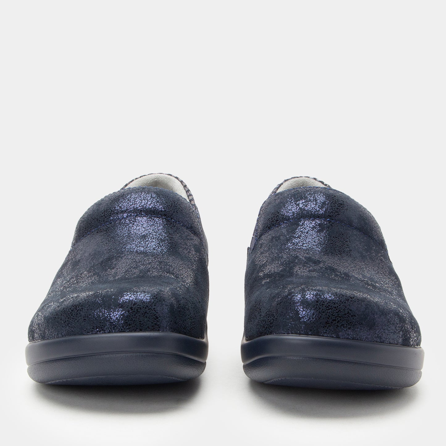Pair of blue slip-on shoes on a white background
