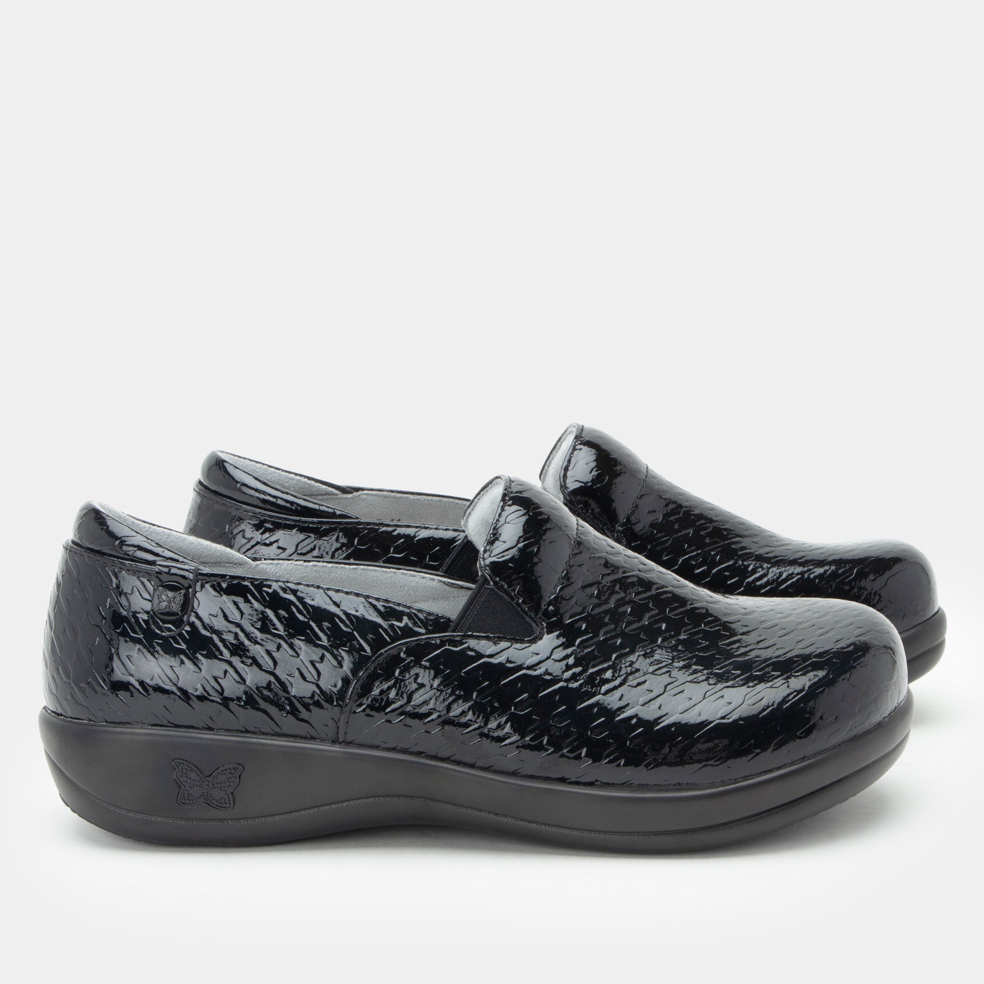 Black patent leather shoes on a white background