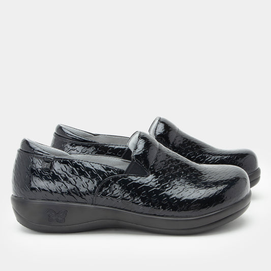 Black patent leather shoes on a white background