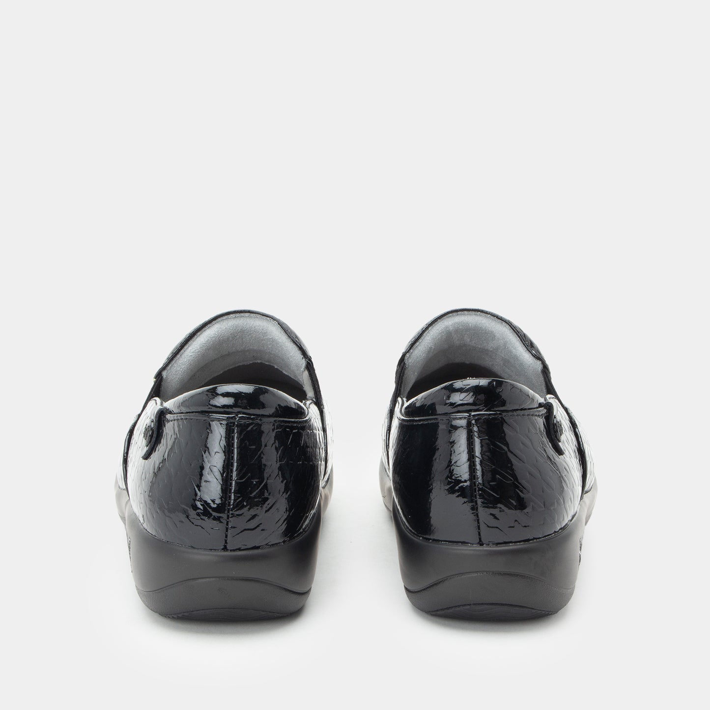 Black patent leather shoes on a white background