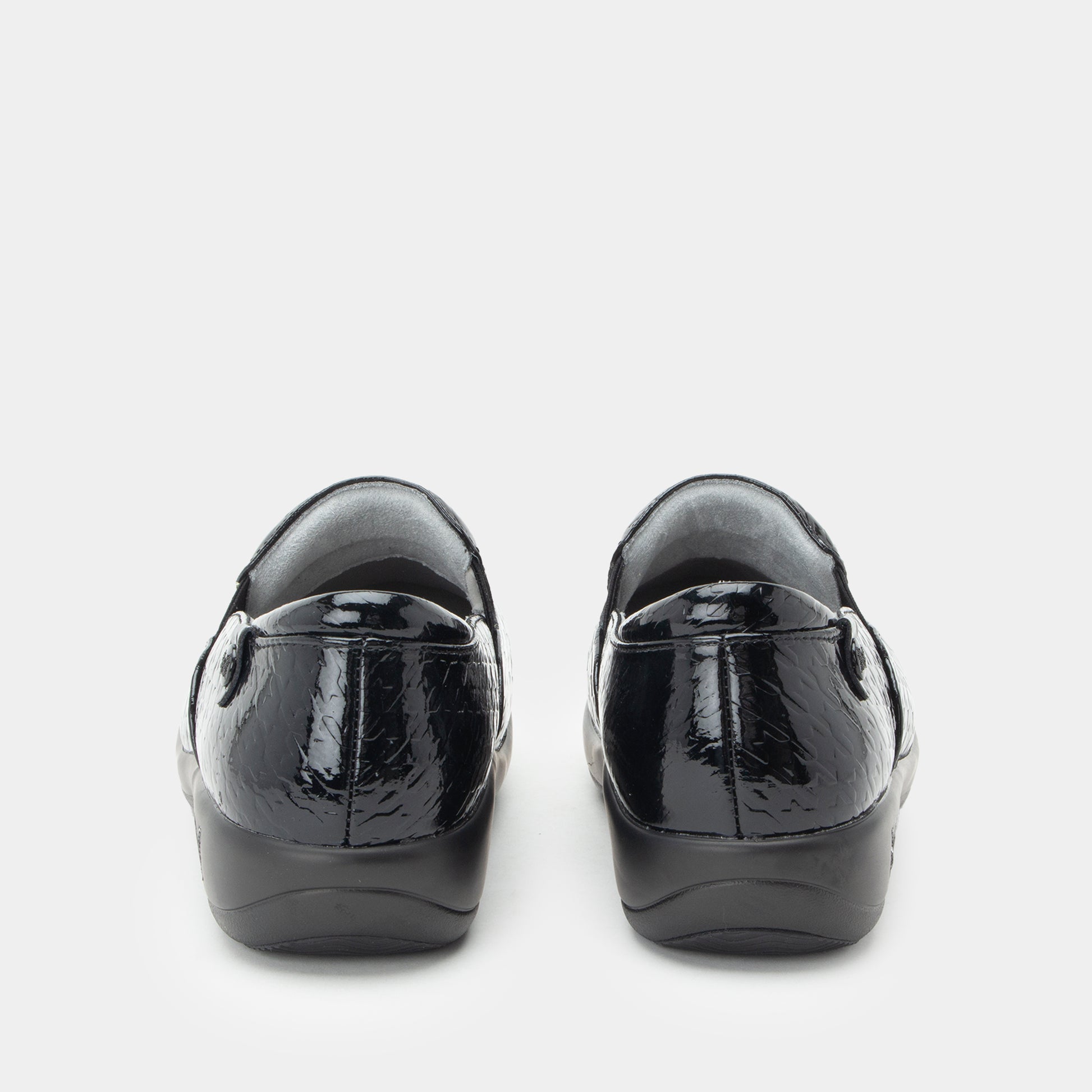 Black patent leather shoes on a white background