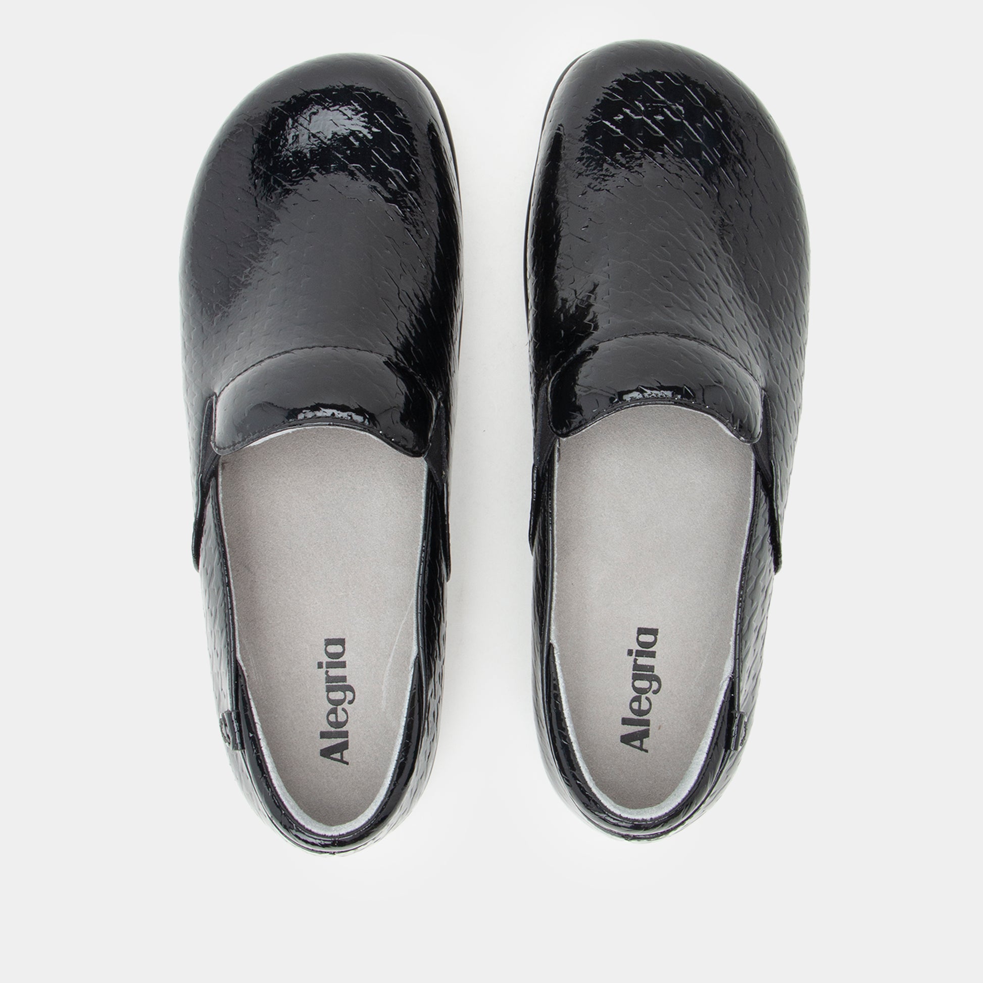 Black patent leather clogs with 'Alegria' branding on a white background