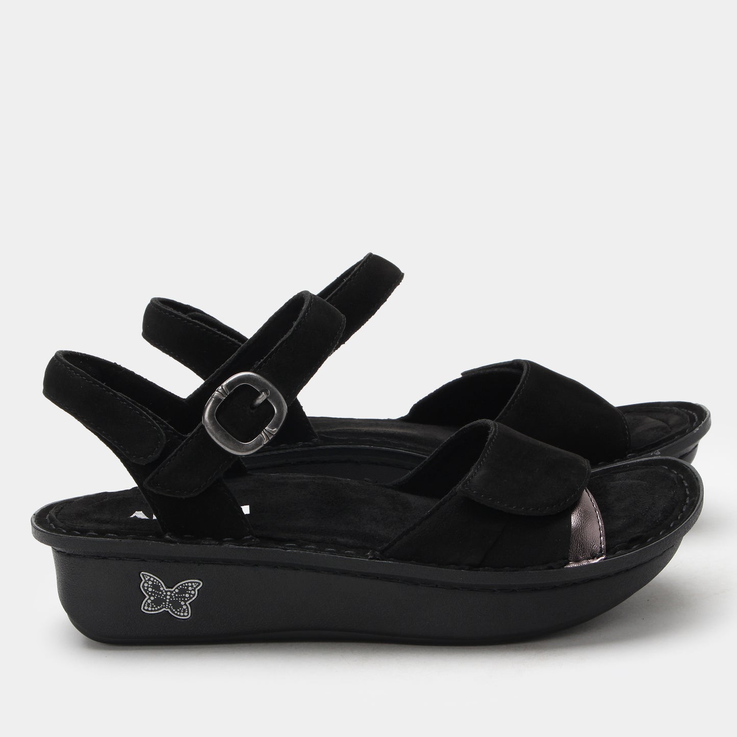 Black sandals with a decorative buckle on a white background