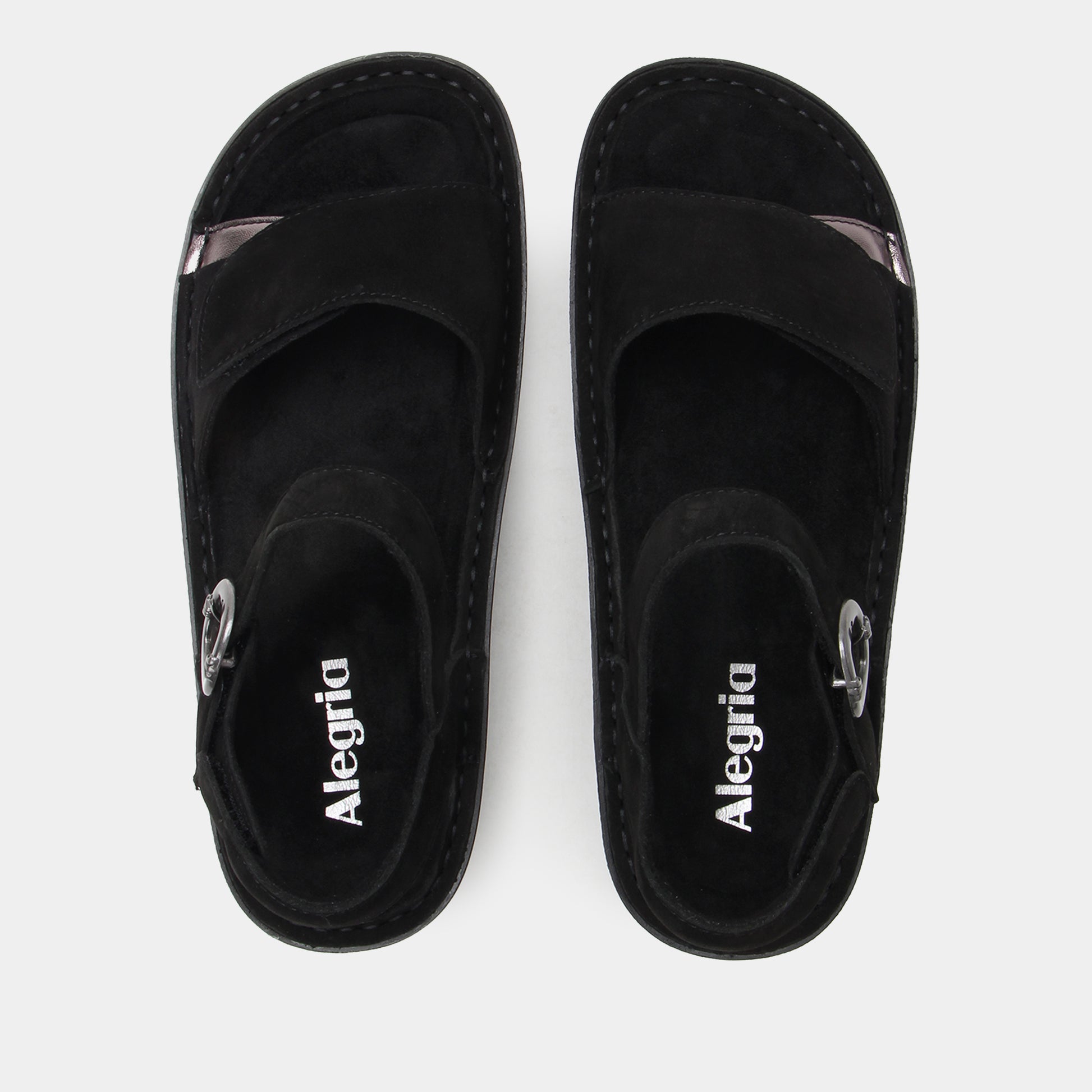 Black Alegria sandals on a white background