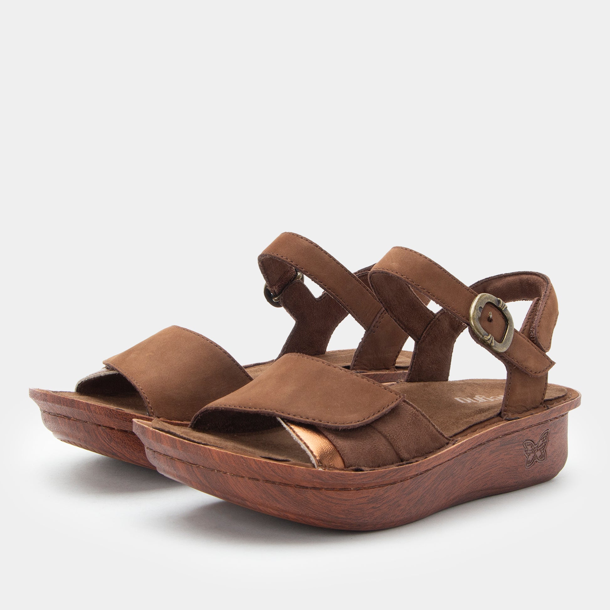 Brown sandals with a strap and buckle on a white background