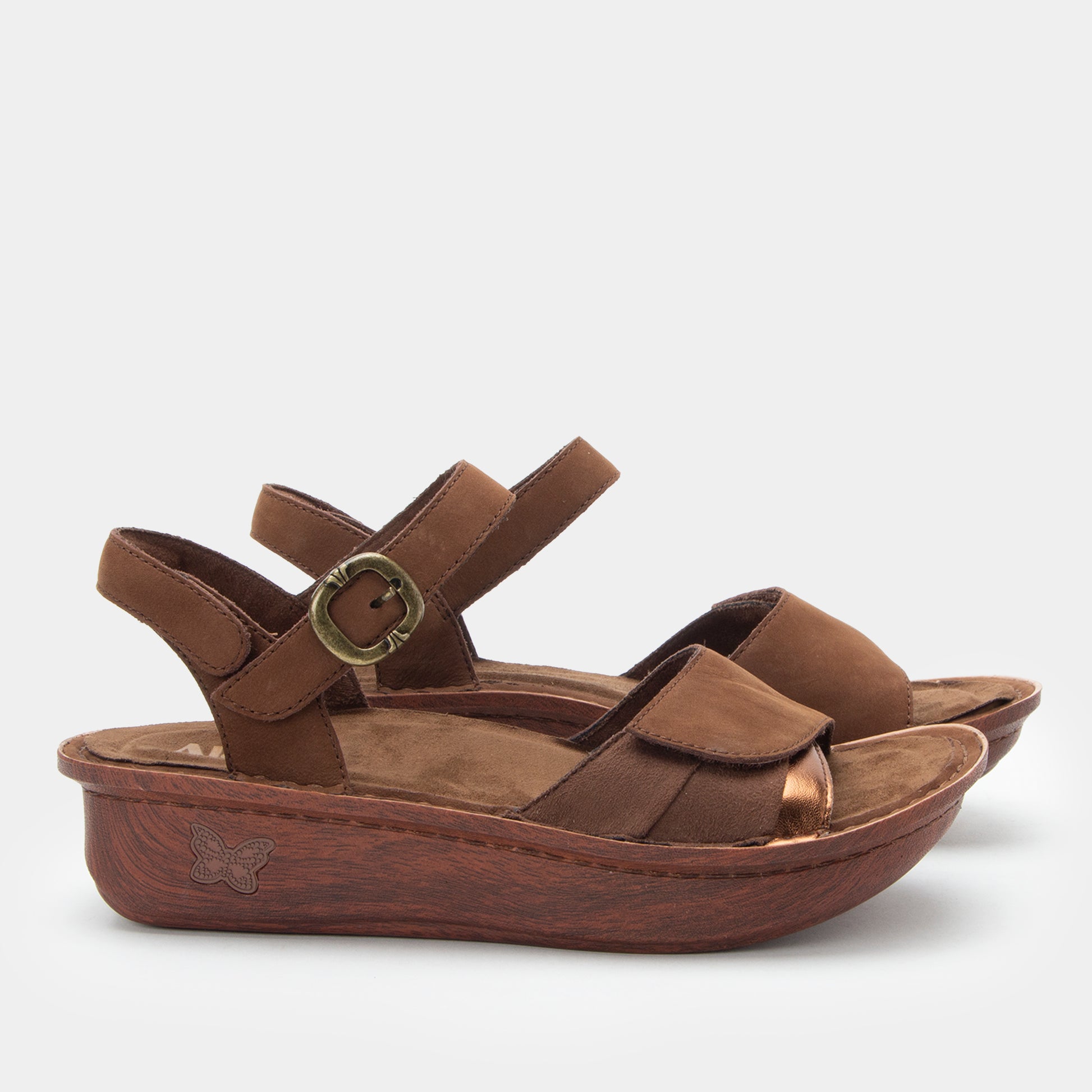 Brown sandal with wooden sole on a white background