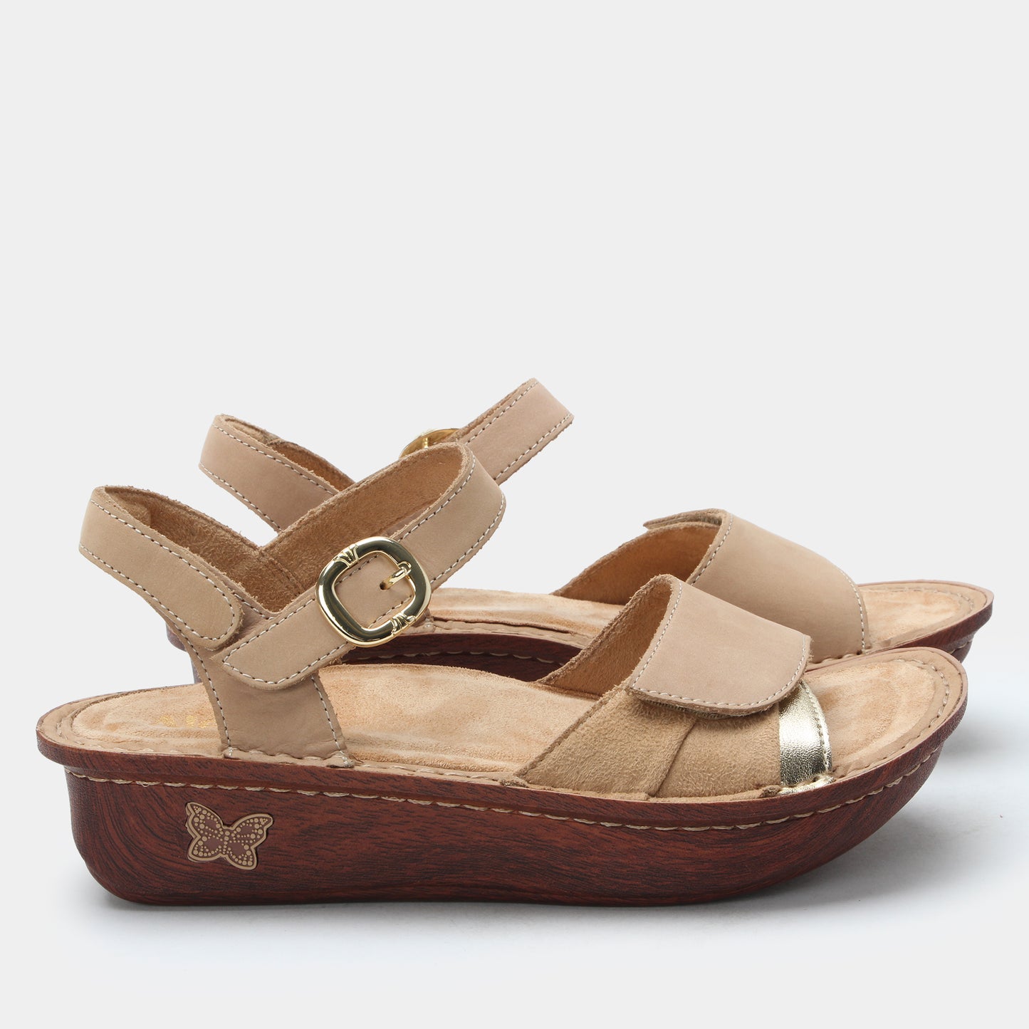 Beige sandal with brown sole on a white background