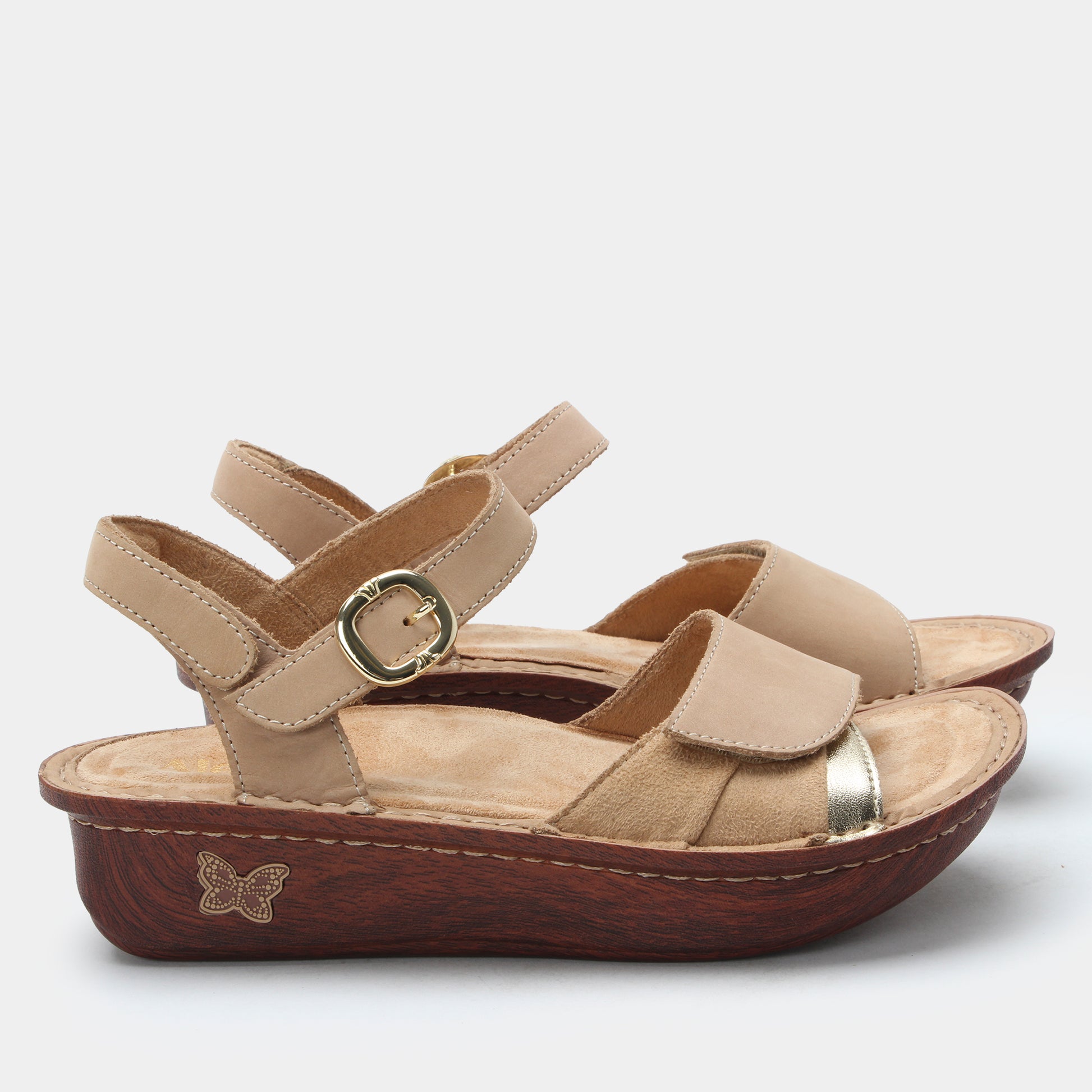 Beige sandal with brown sole on a white background