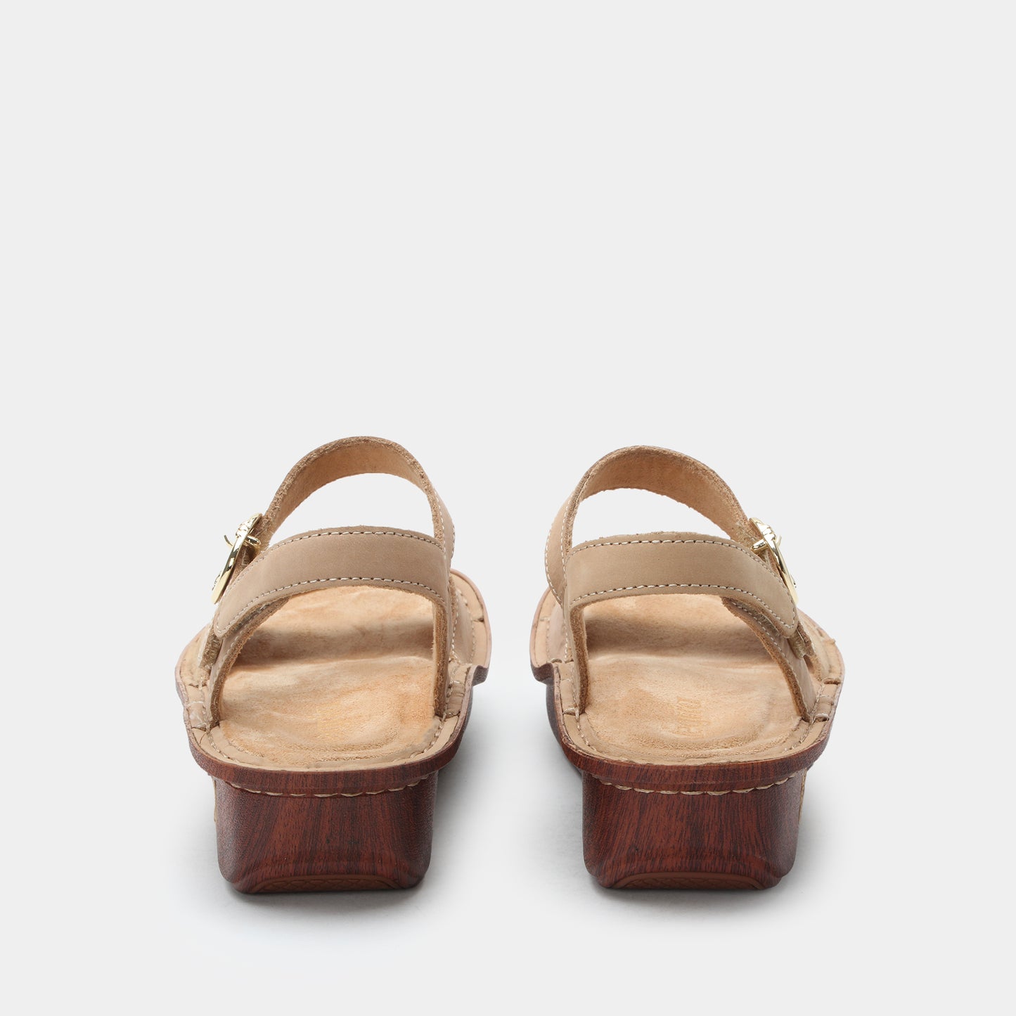 Pair of brown sandals with a white background
