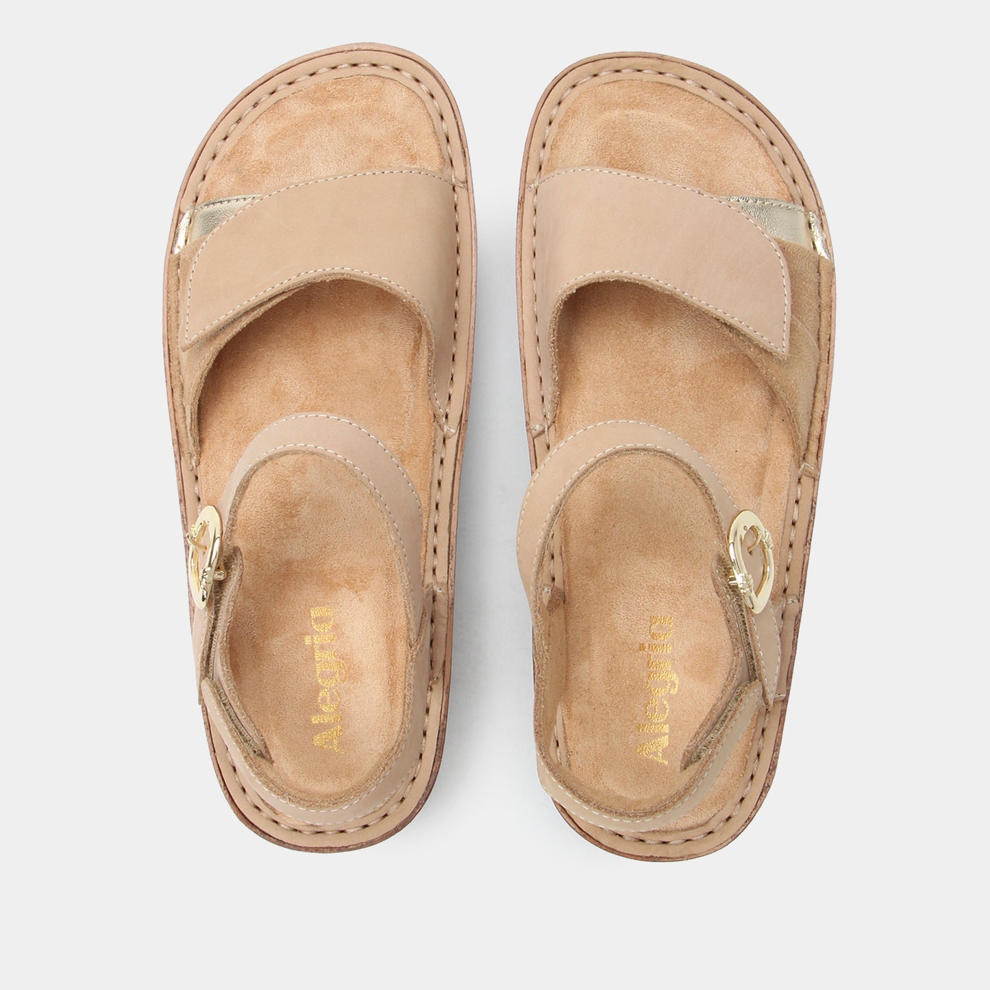 Pair of beige sandals on a white background