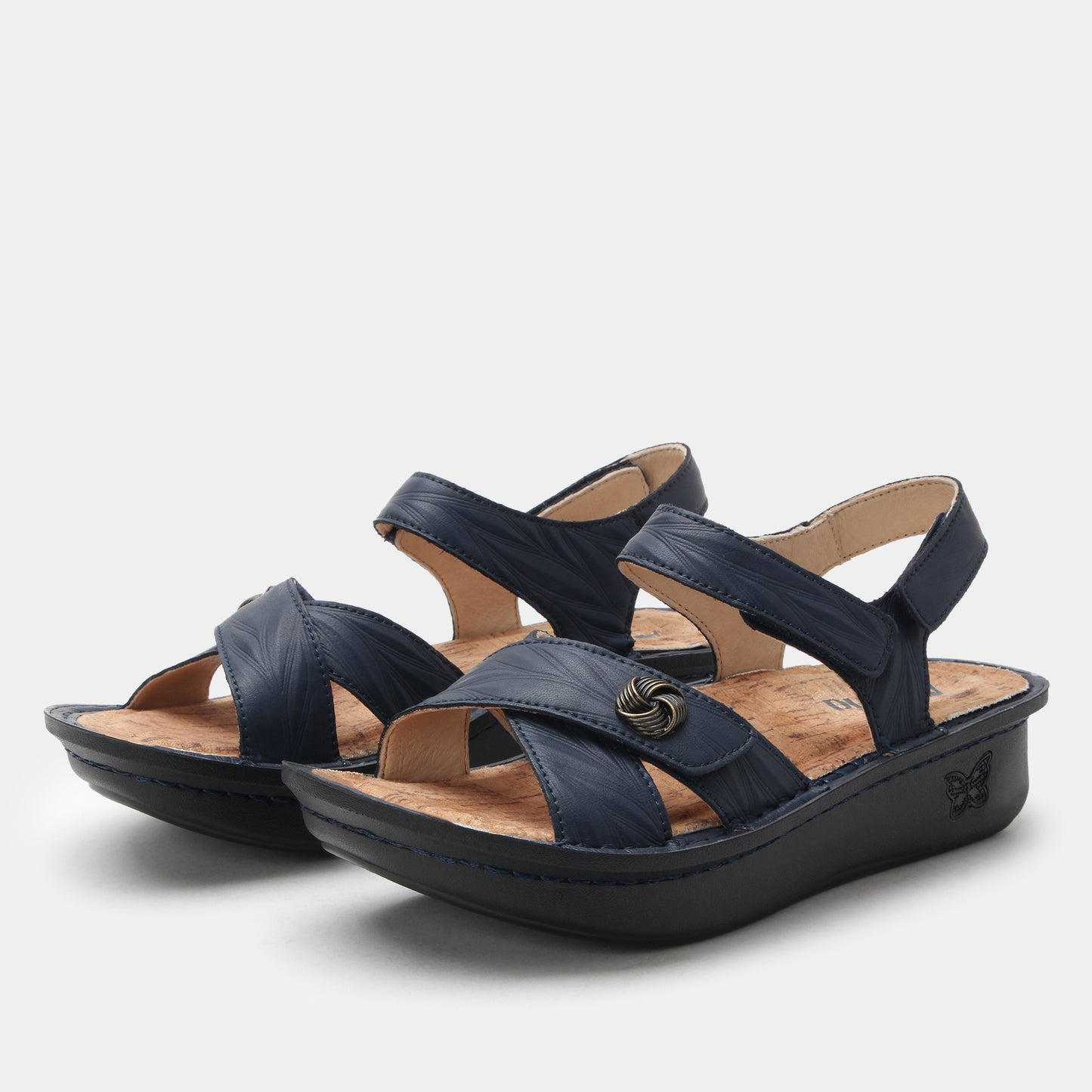 Pair of navy blue sandals on a light gray background