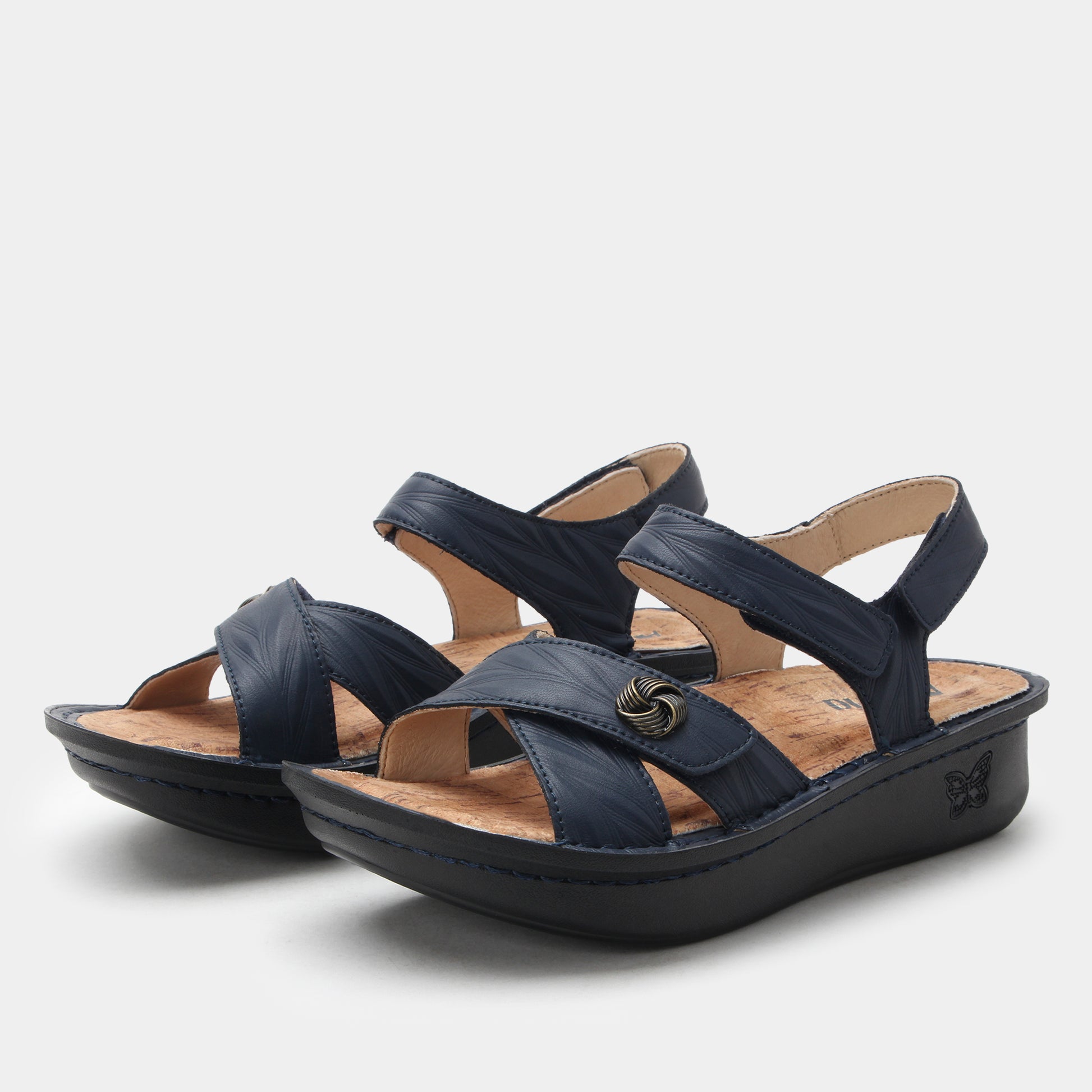 Pair of navy blue sandals on a light gray background