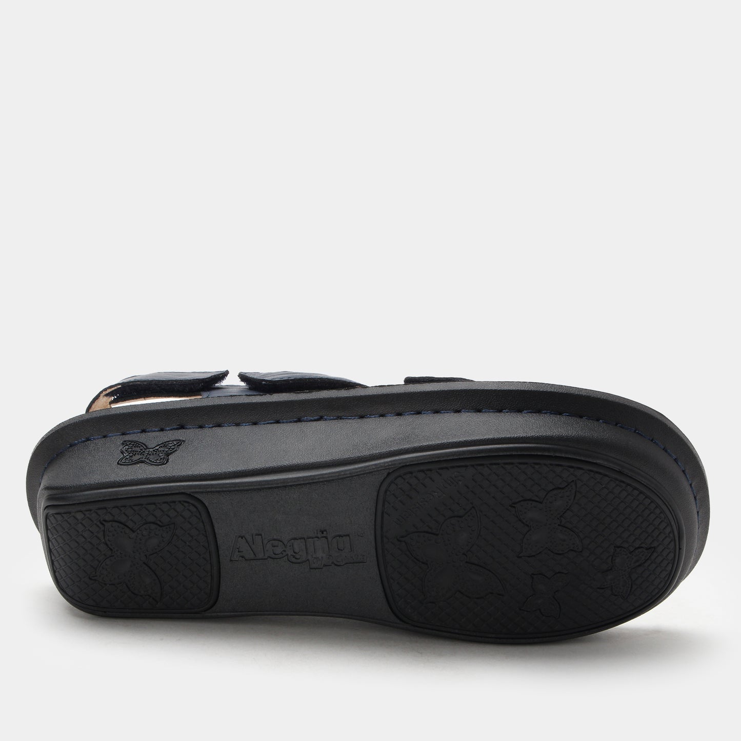 Black sandal with a visible brand logo on a light gray background