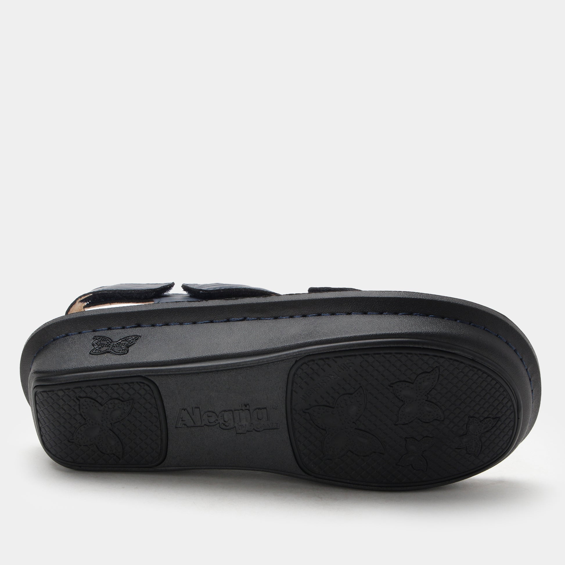 Black sandal with a visible brand logo on a light gray background