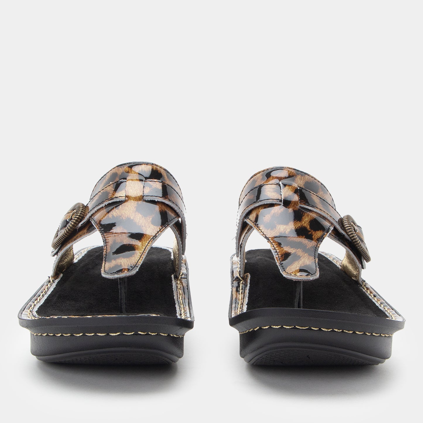 Pair of leopard print sandals on a white background