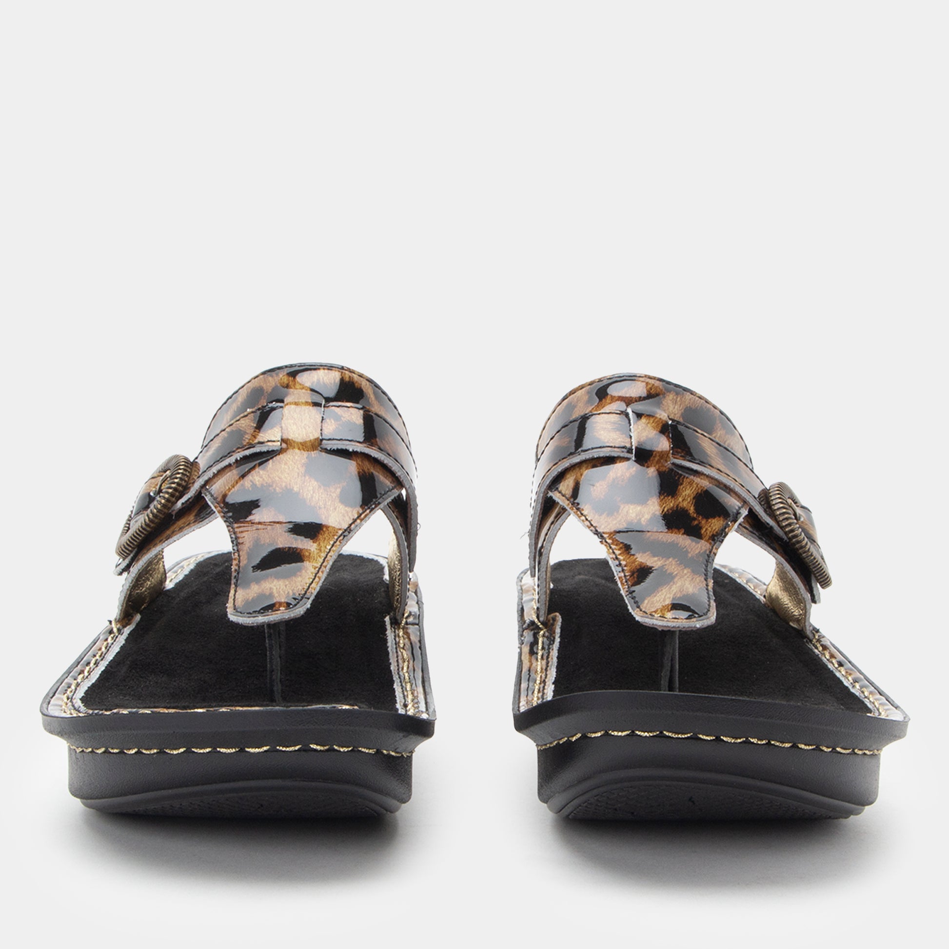 Pair of leopard print sandals on a white background